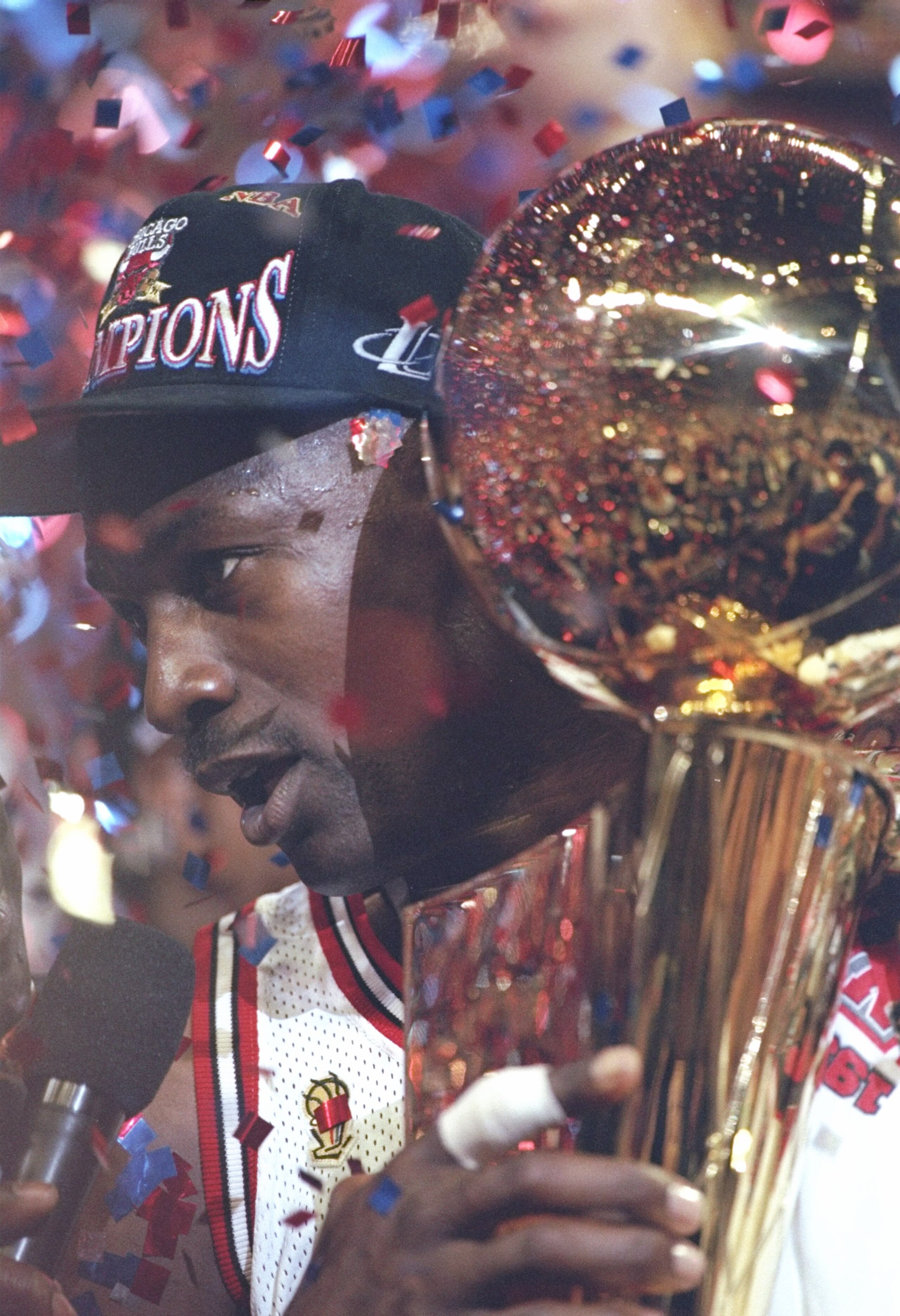 13 Jun 1997: Guard Michael Jordan of the Chicago Bulls holds the NBA trophy as he speaks to a reporter after winning game 6 of the 1997 NBA Finals at the United Center in Chicago, Illinois. The Bulls defeated the Jazz 90-86 to win the series and claim the