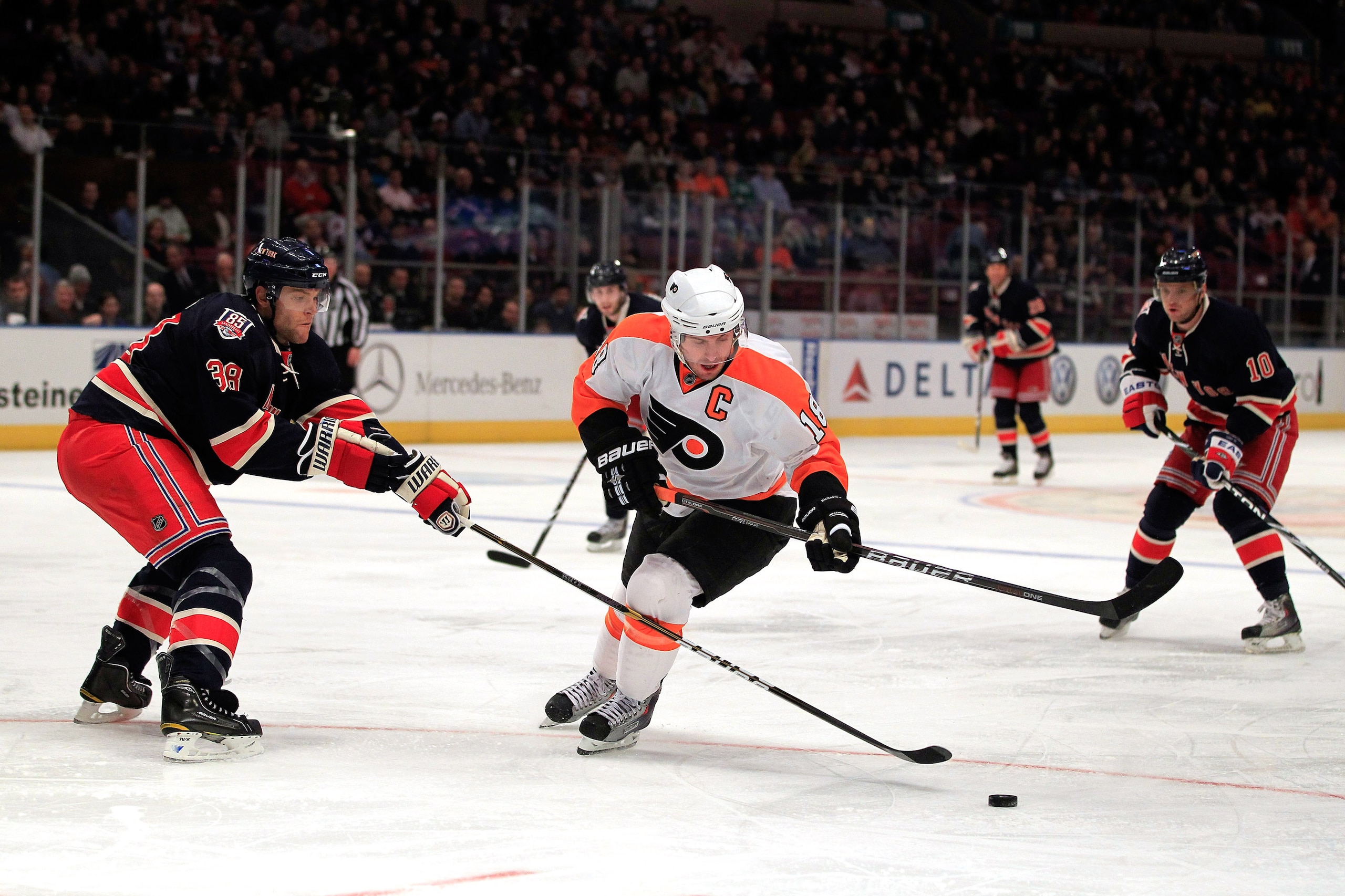 NEW YORK, NY - FEBRUARY 20:  Mike Richards #18 of the Philadelpia Flyers battles for the puck with Michael Sauer #38 of the New York Rangers at Madison Square Garden on February 20, 2011 in New York City.  (Photo by Chris Trotman/Getty Images)