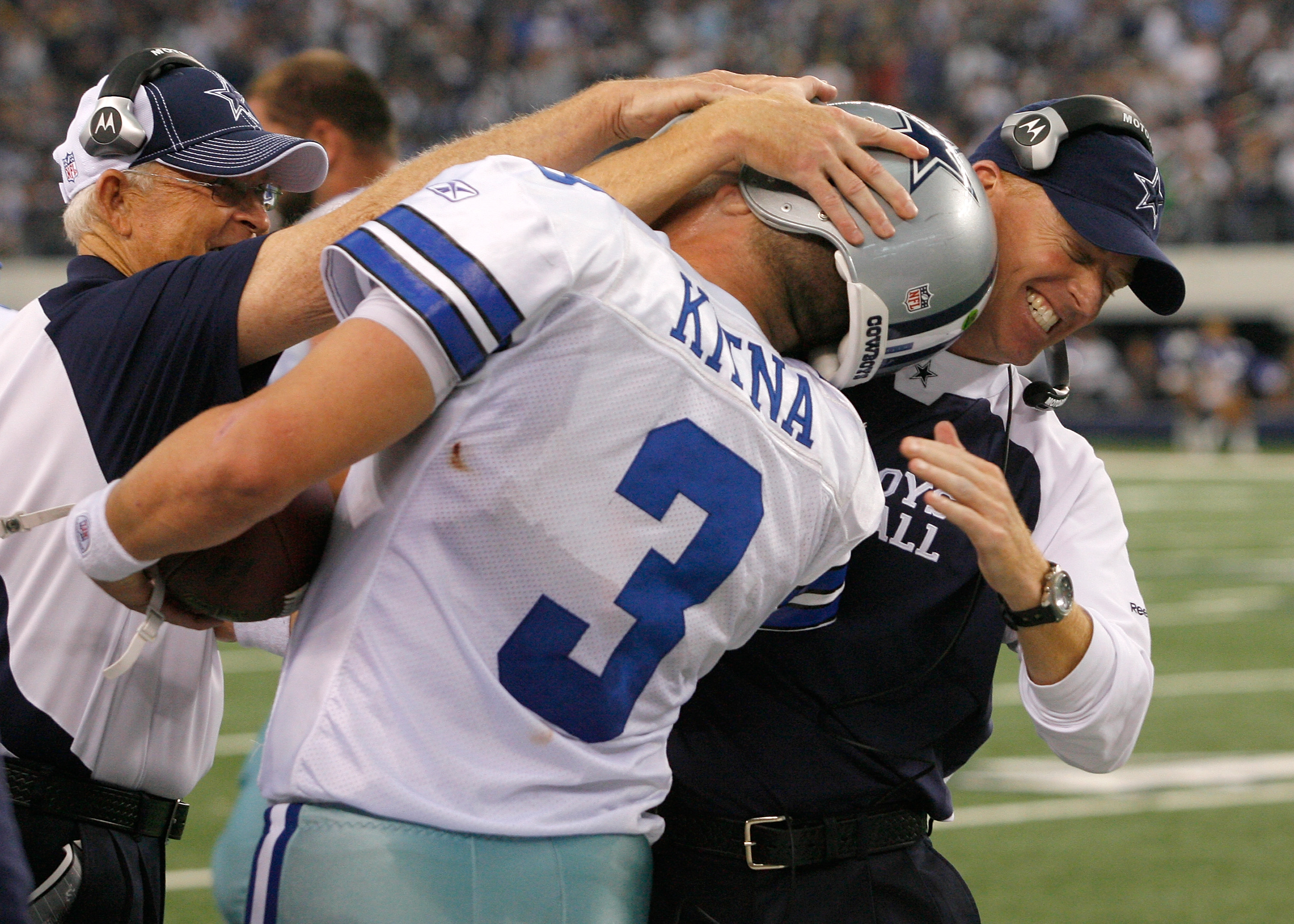 Dallas Cowboys offensive coordinator Jason Garrett (R) talks to quarterback  Tony Romo late in the fourth quarter against the Denver Broncos at Invesco  Field at Mile High in Denver on October 4