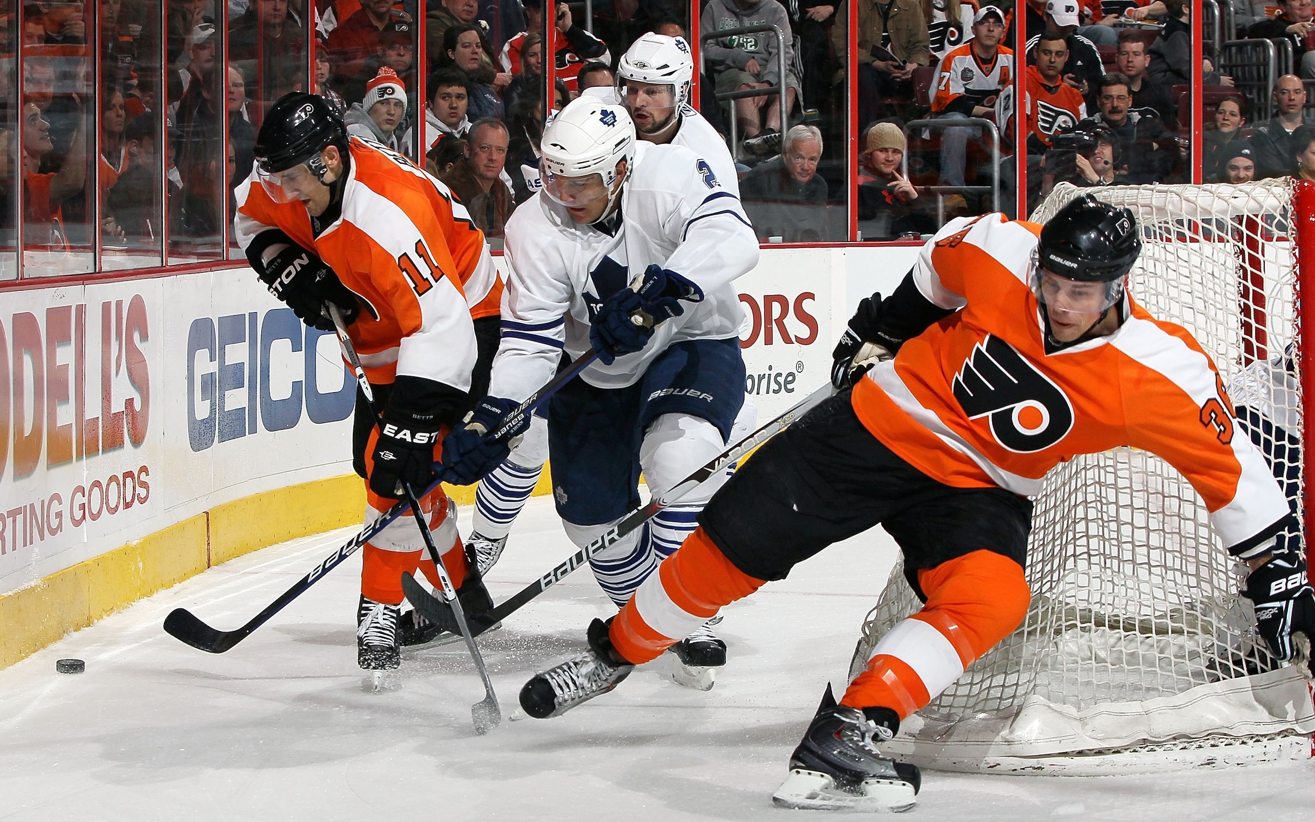 PHILADELPHIA - MARCH 07:  Luke Schenn #2 of the Toronto Maple Leafs skates against Blair Betts #11 and Darroll Powe #36 of the Philadelphia Flyers on March 7, 2010 at Wachovia Center in Philadelphia, Pennsylvania.  (Photo by Jim McIsaac/Getty Images)