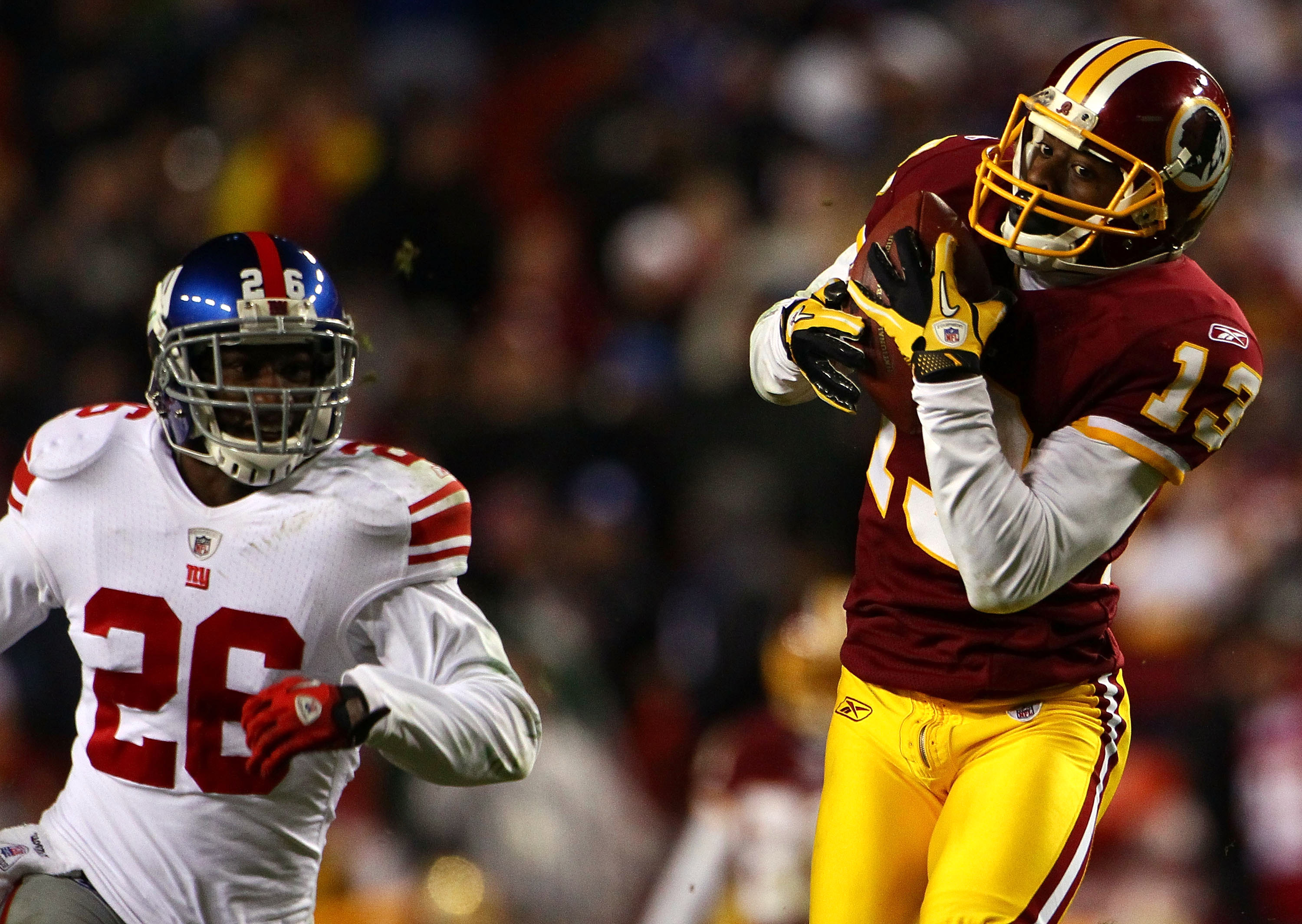 LANDOVER, MD - JANUARY 02:  Wide receiver Anthony Armstrong #13 of the Washington Redskins catches a touchdown pass over Antrel Rolle #26 of the New York Giants during the game at FedEx Field on January 2, 2011 in Landover, Maryland. The Giants won the ga