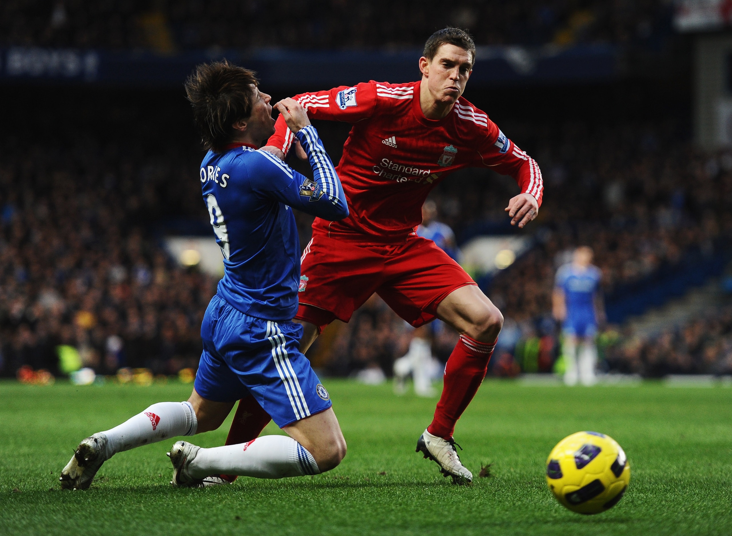 LONDON, ENGLAND - FEBRUARY 06:  Fernando Torres of Chelsea holds his face after a  is challenge by Daniel Agger of Liverpool during the Barclays Premier League match between Chelsea and Liverpool at Stamford Bridge on February 6, 2011 in London, England.