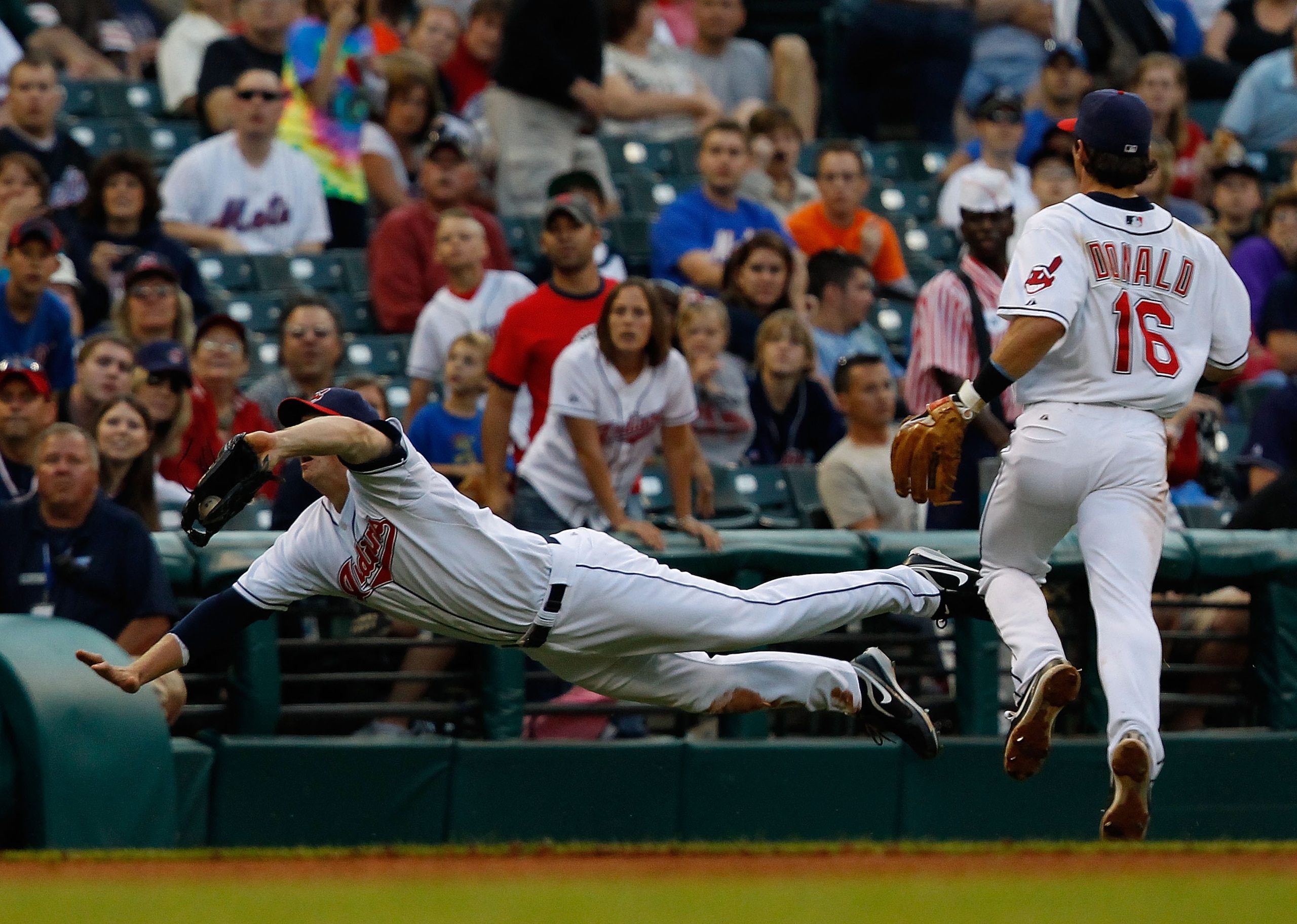 CLEVELAND - JUNE 17: Shelley Duncan #47 of the Cleveland Indians makes a catch in foul territory in front of teammate Jason Donald #16 against the New York Mets during the game on June 17, 2010 at Progressive Field in Cleveland, Ohio. (Photo by Jared Wi CLEVELAND - JUNE 17: Shelley Duncan #47 of the Cleveland Indians makes a catch in foul territory in front of teammate Jason Donald #16 against the New York Mets during the game on June 17, 2010 at Progressive Field in Cleveland, Ohio. (Photo by Jared Wi
