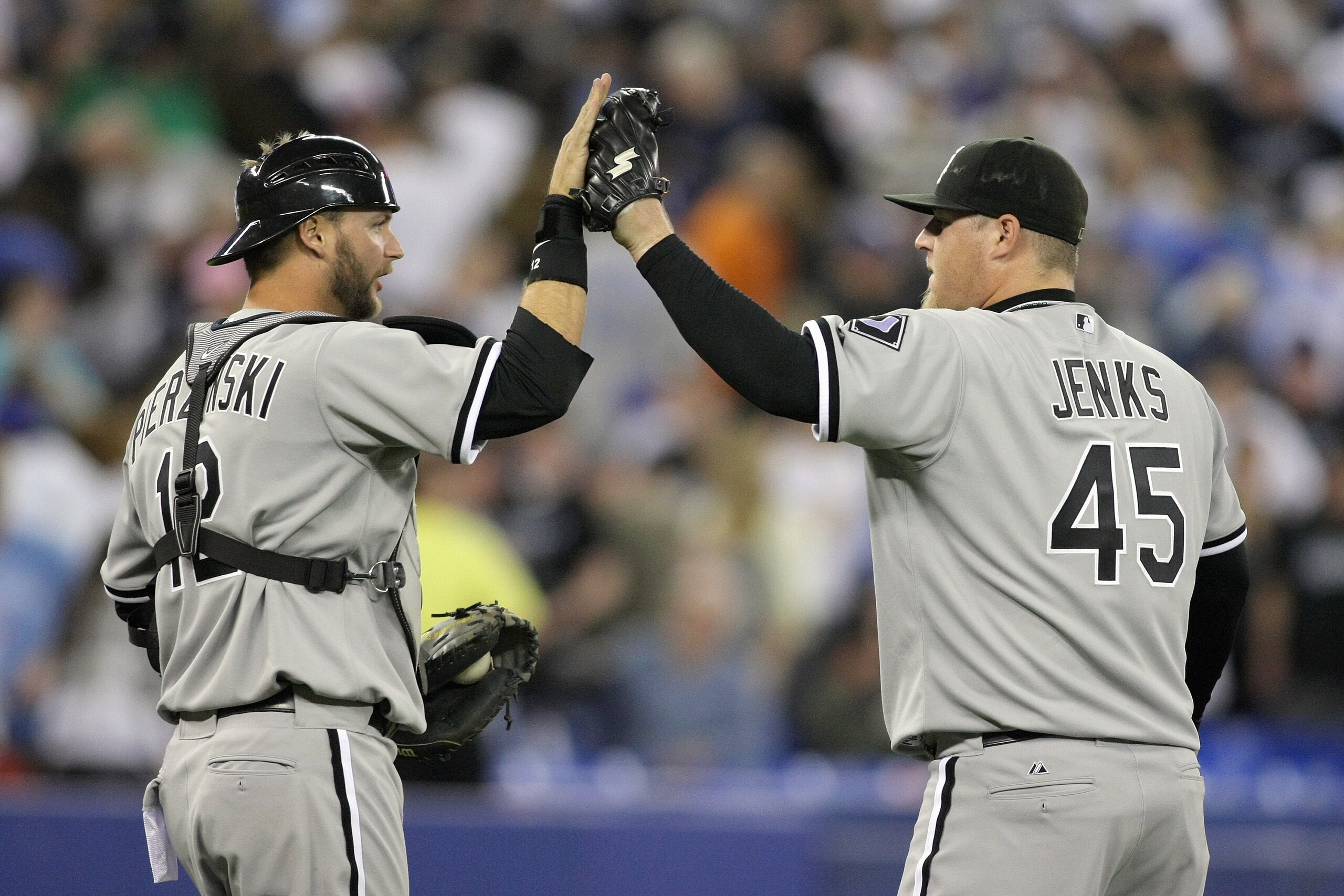 TORONTO - APRIL 12: Catcher A.J. Pierzynski #12 and pitcher Bobby Jenks #45 of the Chicago White Sox celebrate against the Toronto Blue Jays during their MLB game at the Rogers Centre on April 12, 2010 in Toronto, Ontario. (Photo By Dave Sandford/Getty Im TORONTO - APRIL 12: Catcher A.J. Pierzynski #12 and pitcher Bobby Jenks #45 of the Chicago White Sox celebrate against the Toronto Blue Jays during their MLB game at the Rogers Centre on April 12, 2010 in Toronto, Ontario. (Photo By Dave Sandford/Getty Im