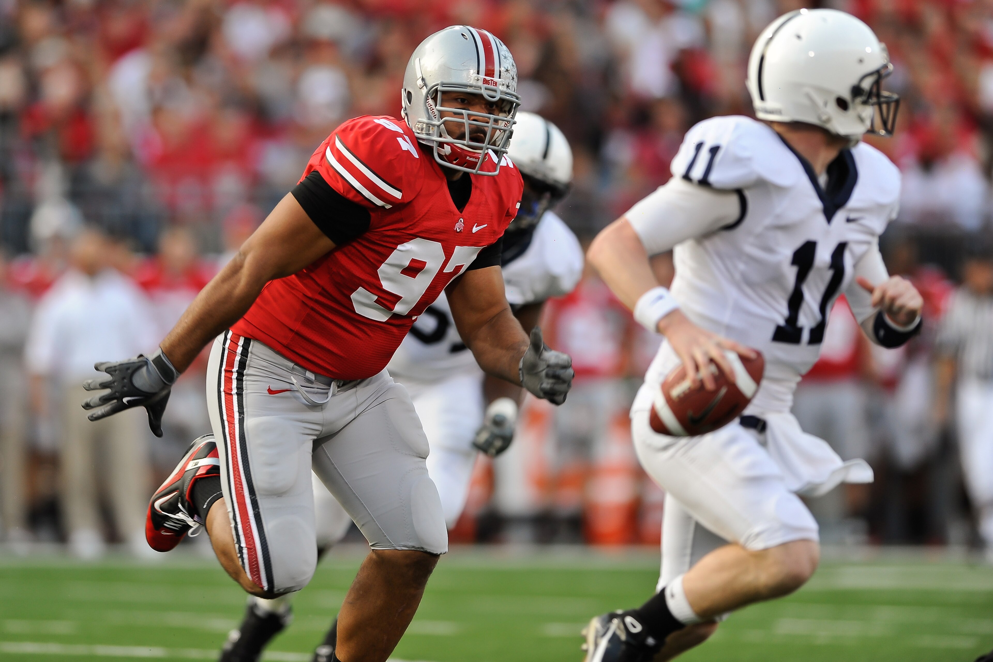 COLUMBUS, OH - NOVEMBER 13:  Cameron Heyward #97 of the Ohio State Buckeyes chases after quarterback Matt McGloin #11 of the Penn State Nittany Lions at Ohio Stadium on November 13, 2010 in Columbus, Ohio.  (Photo by Jamie Sabau/Getty Images)