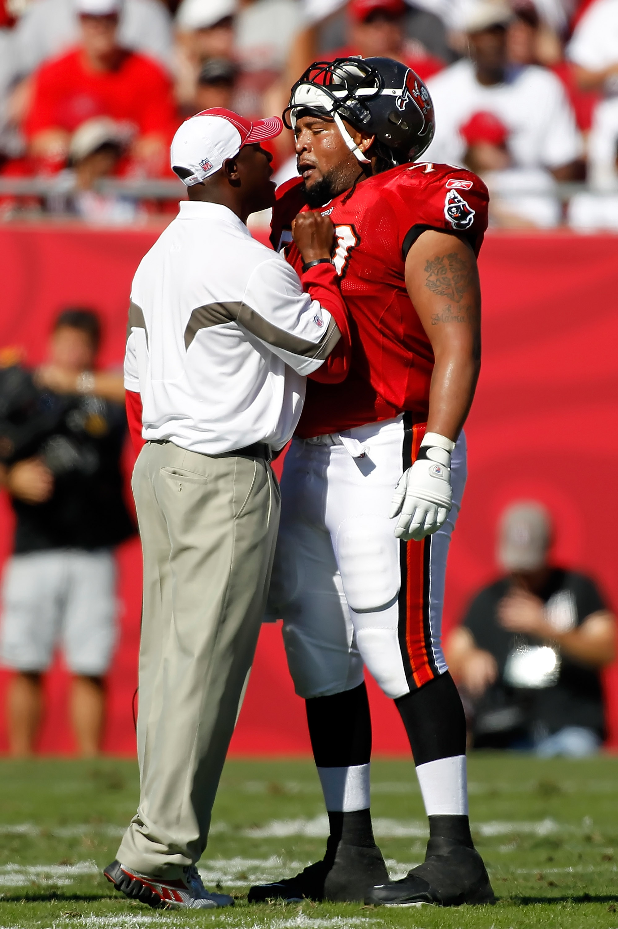 13 SEP 2009: Head Coach Raheem Morris of the Buccaneers in the red shirt  watches the instant replay during the game between the Dallas Cowboys and  the Tampa Bay Buccaneers at Raymond