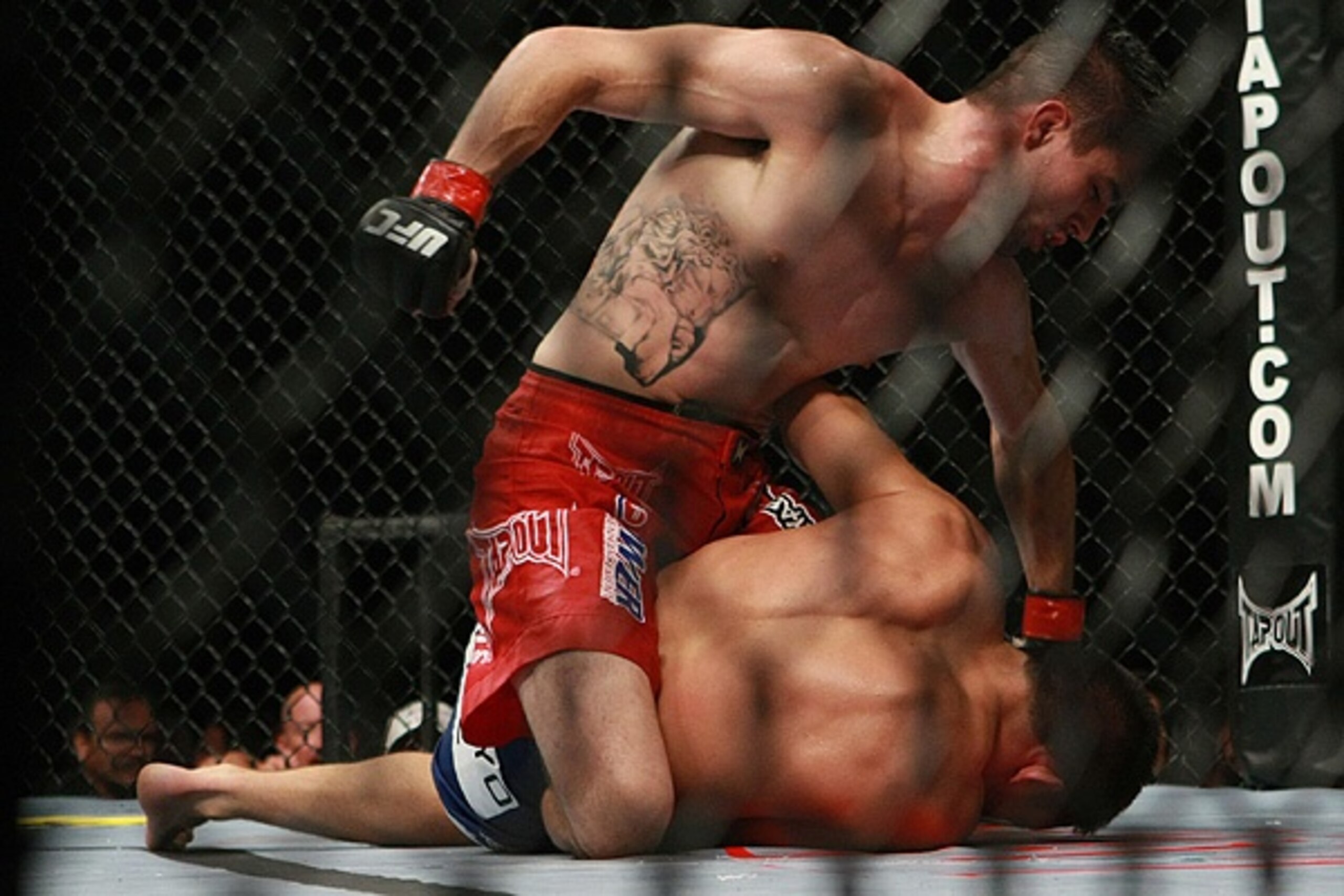 Carlos Condit driving punches into Jake Ellenberger