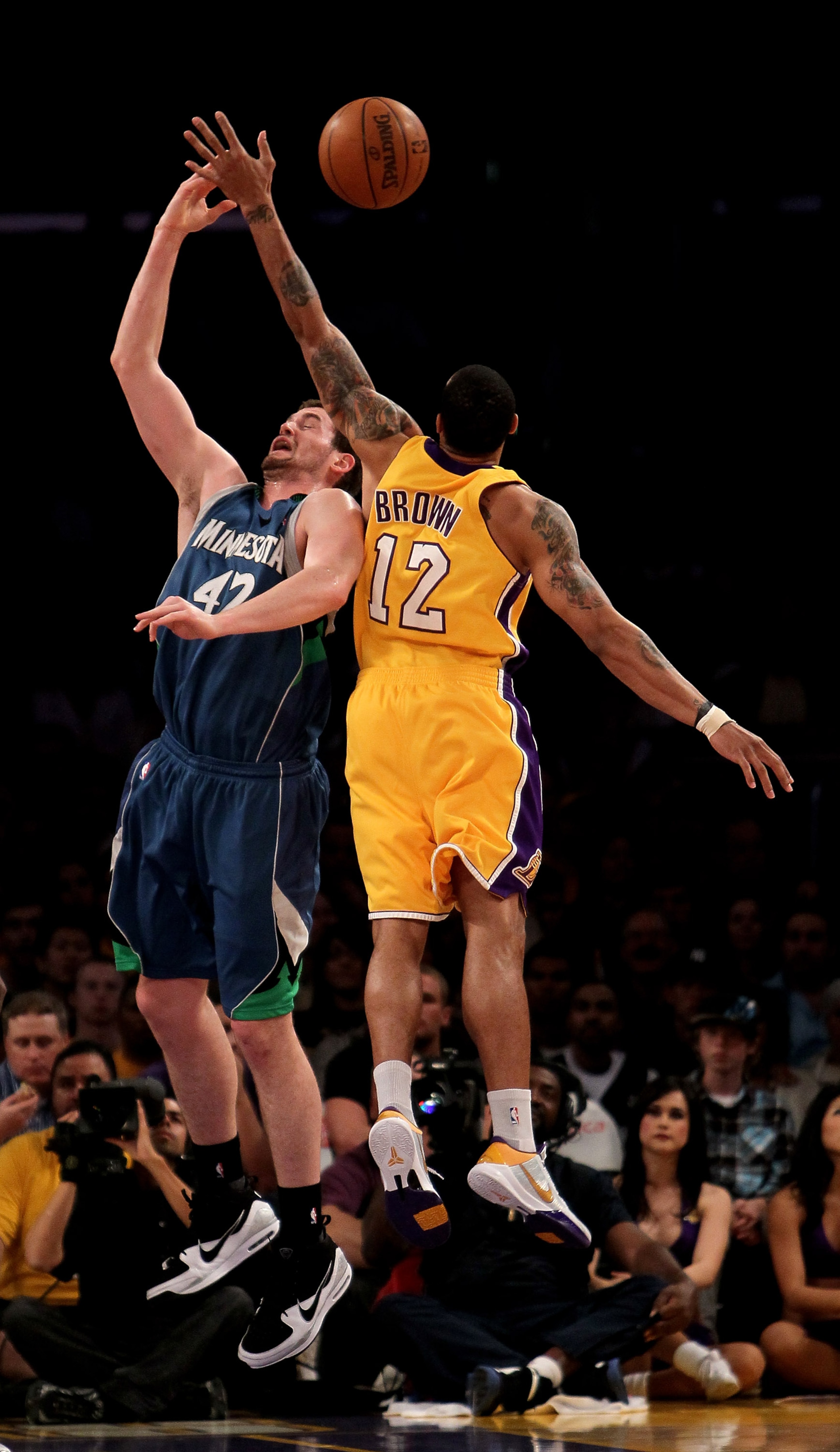 LOS ANGELES - MARCH 19: Shannon Brown #12 of  the Los Angeles Lakers bats a rebound away from Kevin Love #42 of the Minnesota Timberwolves on March 19, 2010 at Staples Center in Los Angeles, California.  NOTE TO USER: User expressly acknowledges and agree