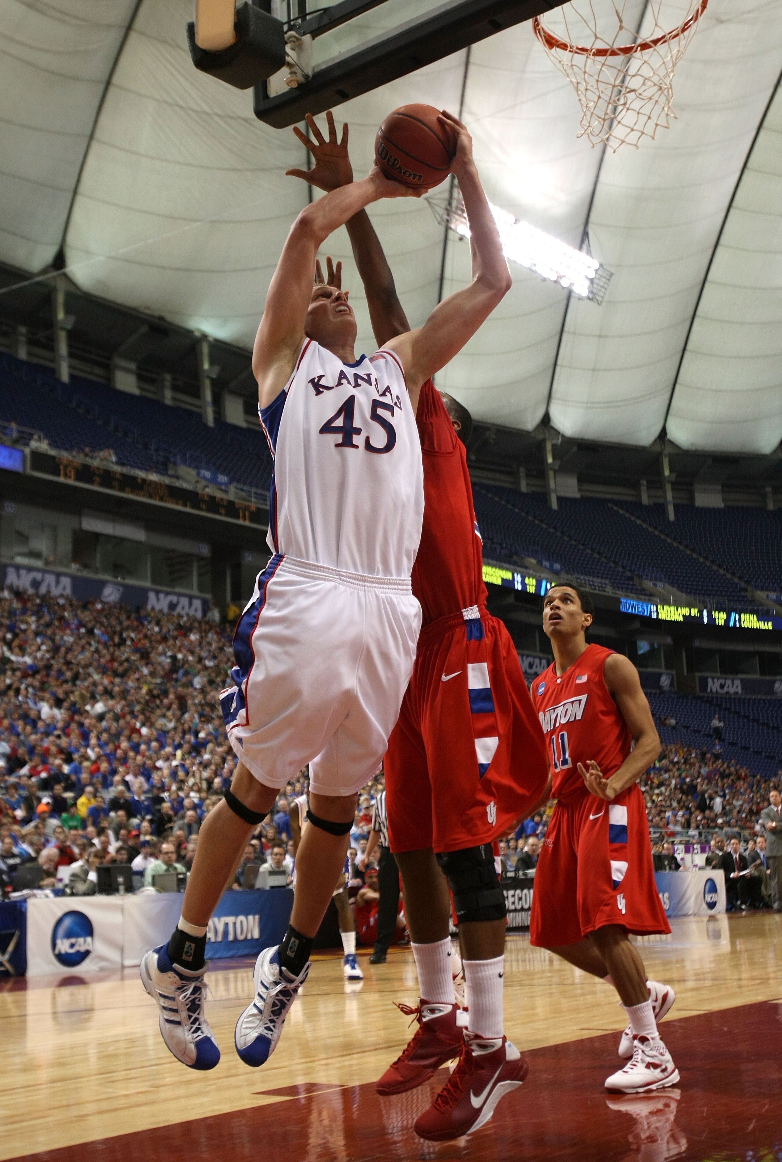 MINNEAPOLIS - MARCH 22:  Cole Aldrich #45 of the Kansas Jayhawks goes up for a shot attempt in the first half against the Dayton Flyers during the second round of the NCAA Division I Men's Basketball Tournament at the Hubert H. Humphrey Metrodome on March