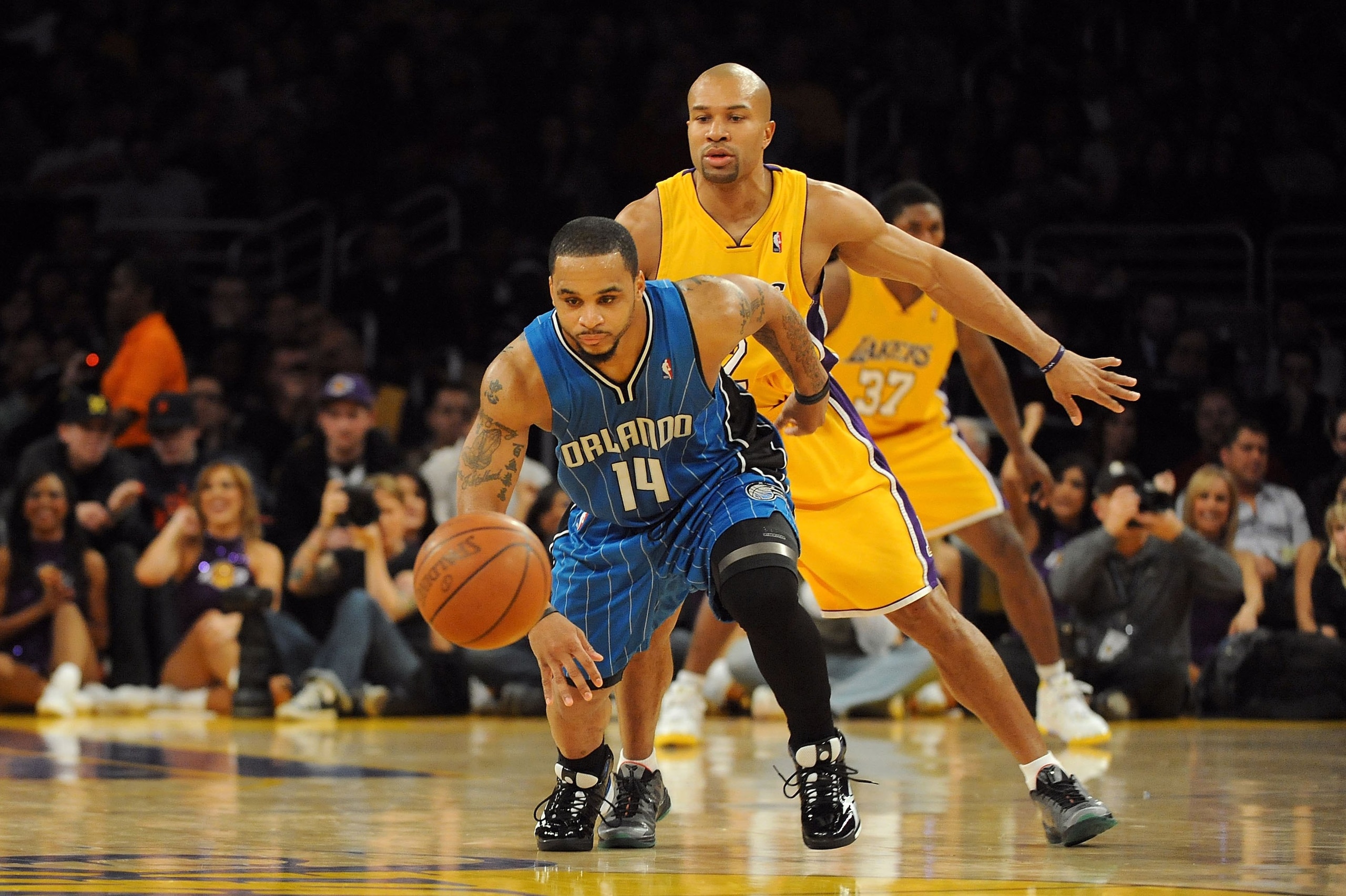 LOS ANGELES, CA - JANUARY 18:  Jameer Nelson #14 of the Orlando Magic goes for the loose ball against Derek Fisher #2 of the Los Angeles Lakers during the game on January 18, 2010 at Staples Center in Los Angeles, California.   The Lakers won 98-92.  NOTE