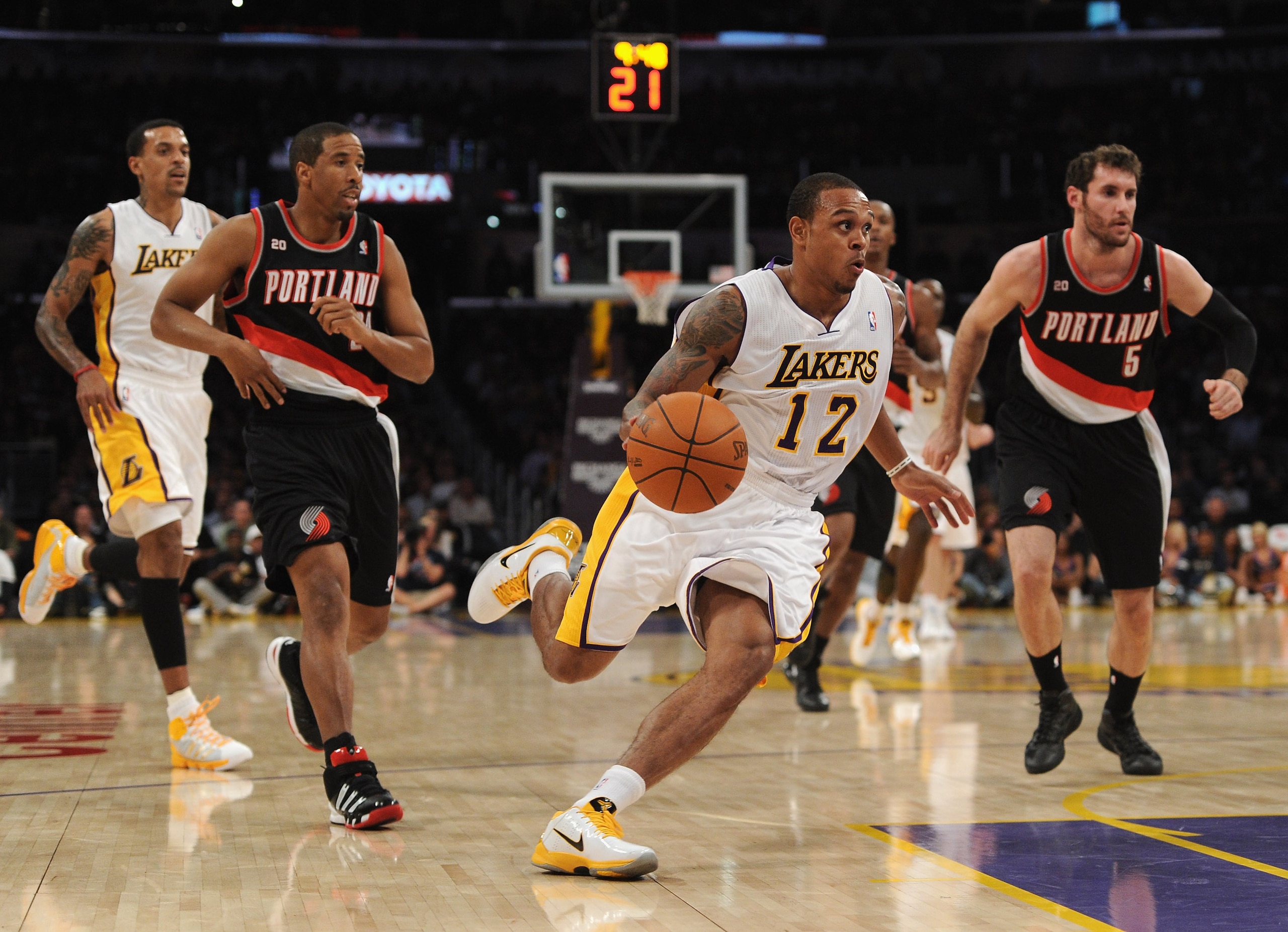 LOS ANGELES, CA - NOVEMBER 07:  Shannon Brown #12 of the Los Angeles Lakers dribbles past Andre Miller #24 and Rudy Fernandez #5 of the Portland Trail Blazers at the Staples Center on November 7, 2010 in Los Angeles, California. The Lakers won 121-96.   N