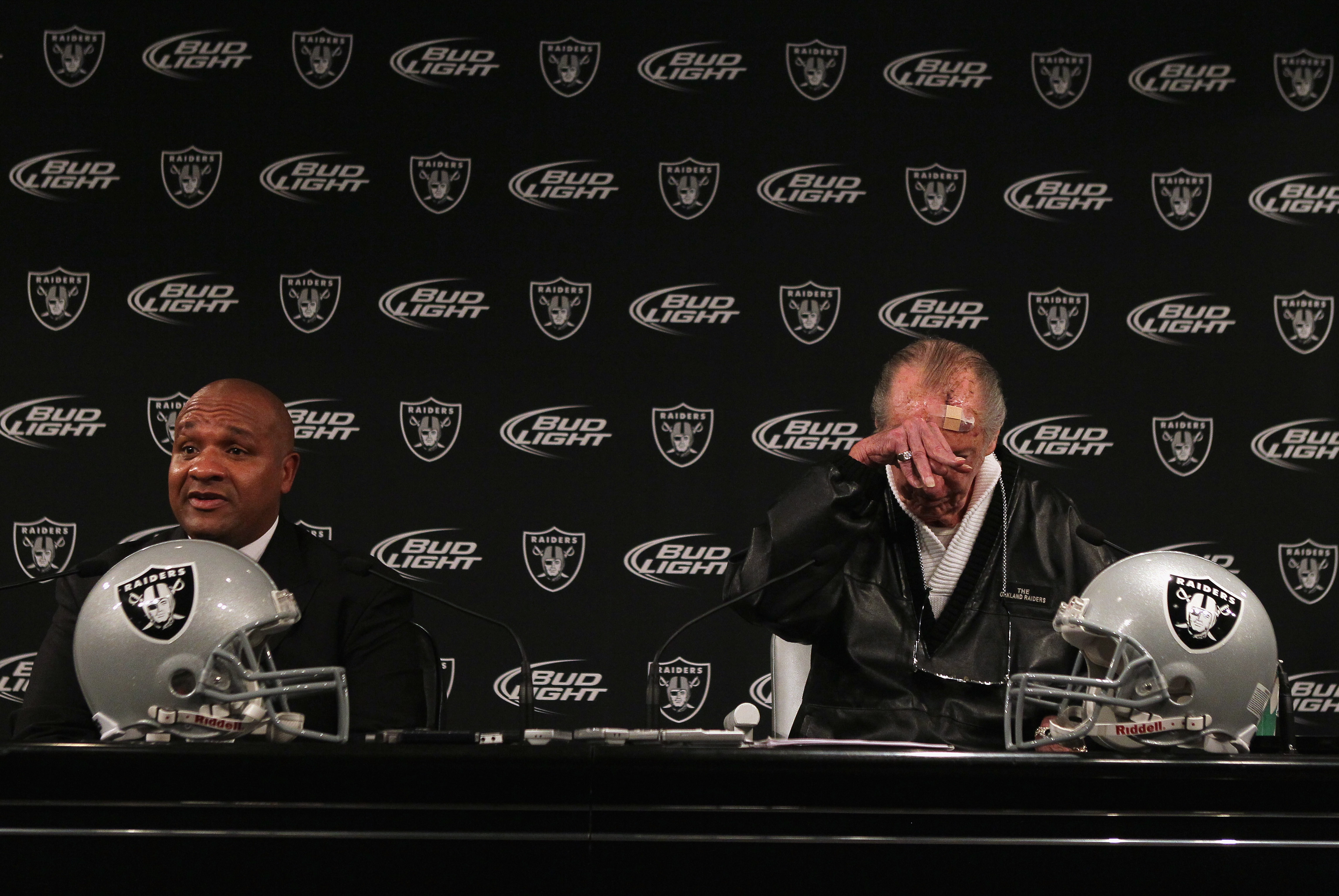 ALAMEDA, CA - JANUARY 18:  New Oakland Raiders coach Hue Jackson (L) speaks to reporters as  Raiders owner Al Davis rubs his head during a press conference on January 18, 2011 in Alameda, California. Hue Jackson was introduced as the new coach of the Oakl