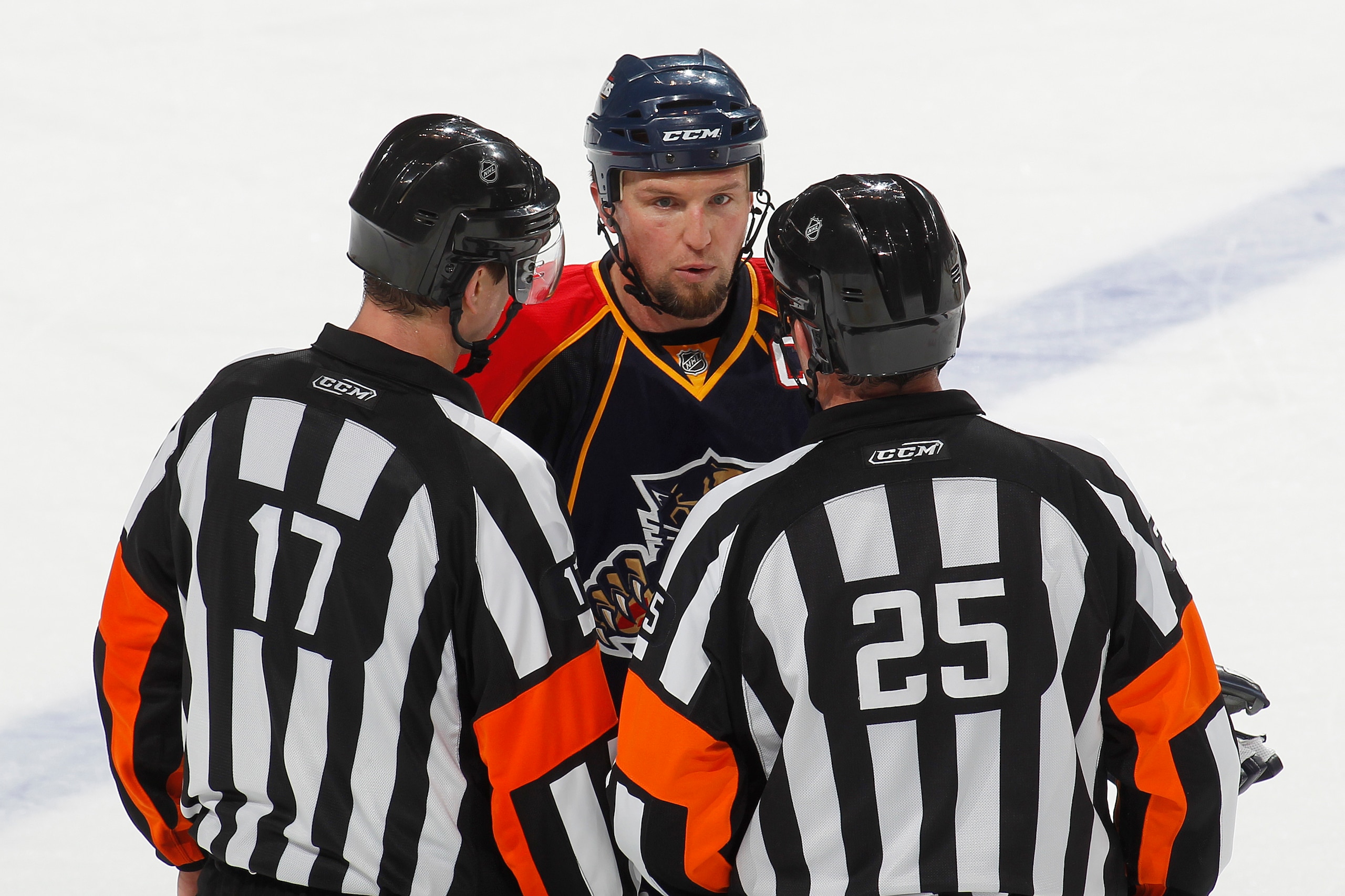 SUNRISE, FL - JANUARY 5: Bryan McCabe #24 of the Florida Panthers discusses a call with referee Frederick L'Ecuyer #17 and referee Marc Joannette #25 in the third period against the Atlanta Thrashers on January 5, 2011 at the BankAtlantic Center in Sunris