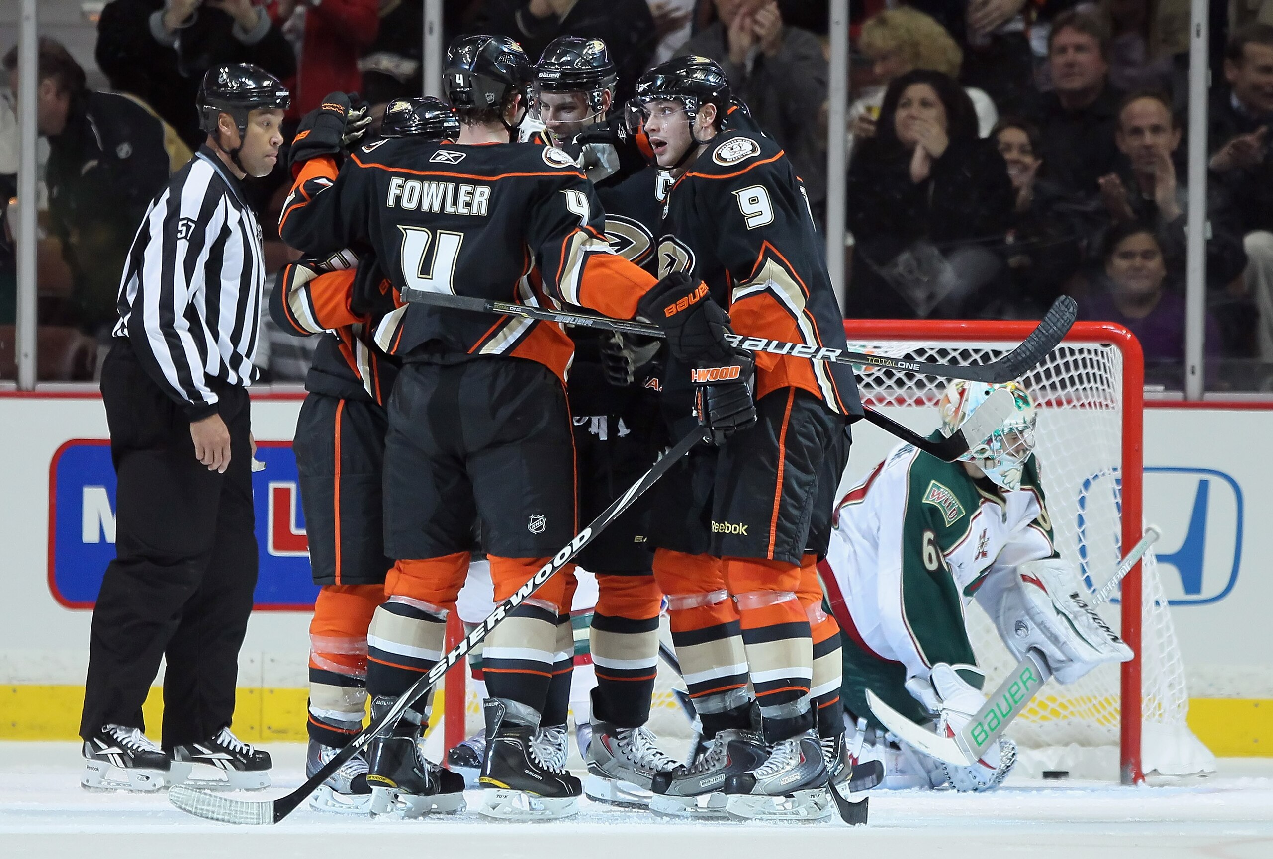 ANAHEIM, CA - FEBRUARY 25:  (L-R) Cam Fowler #4, Ryan Getzlaf #15 and Bobby Ryan #9 of the Anaheim Ducks celebrate Ryan's goal, as goaltender Jose Theodore #60 of the Minnesota Wild collects the puck in the second period at Honda Center on February 25, 20