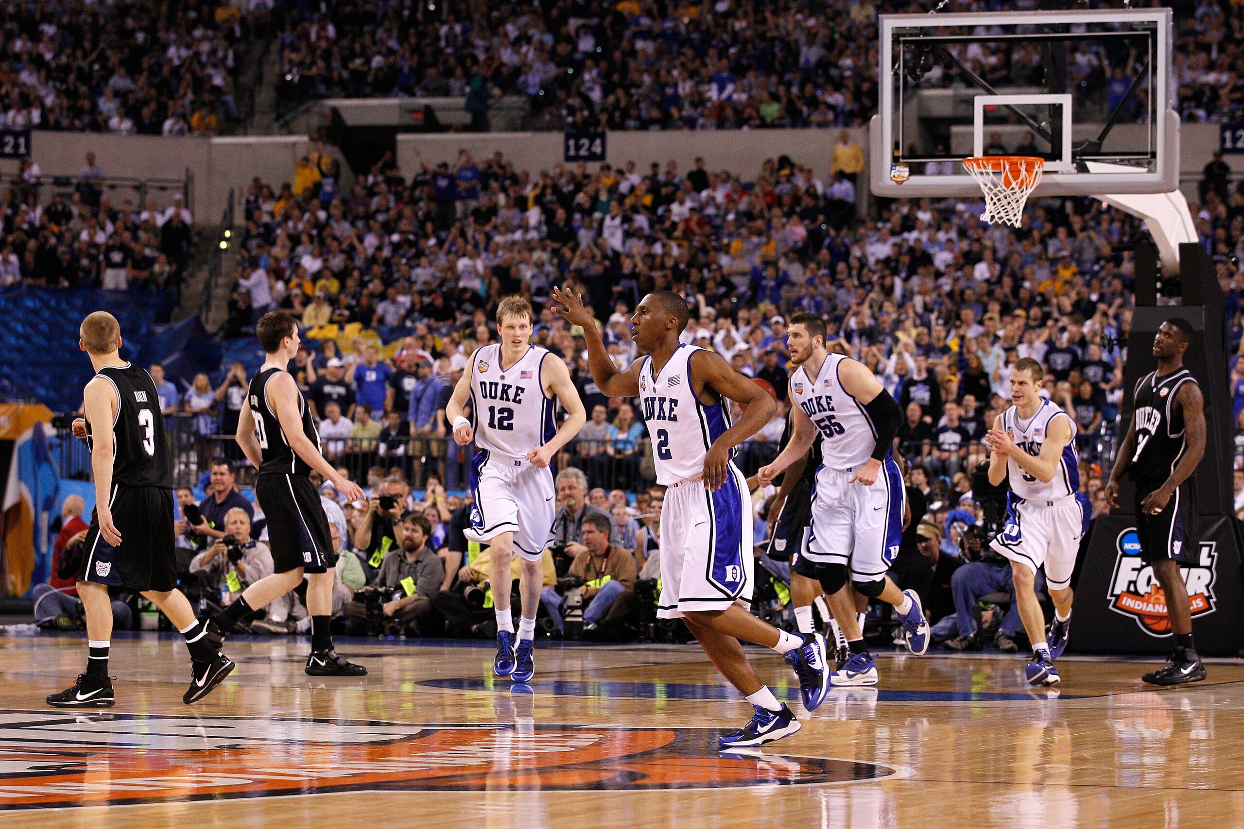 DURHAM, NC - FEBRUARY 23:  Head coach Mike Krzyzewski congratulates players Nolan Smith #2 and Tyler Thornton #3 of the Duke Blue Devils after their 78-61 victory over the Temple Owls at Cameron Indoor Stadium on February 23, 2011 in Durham, North Carolin