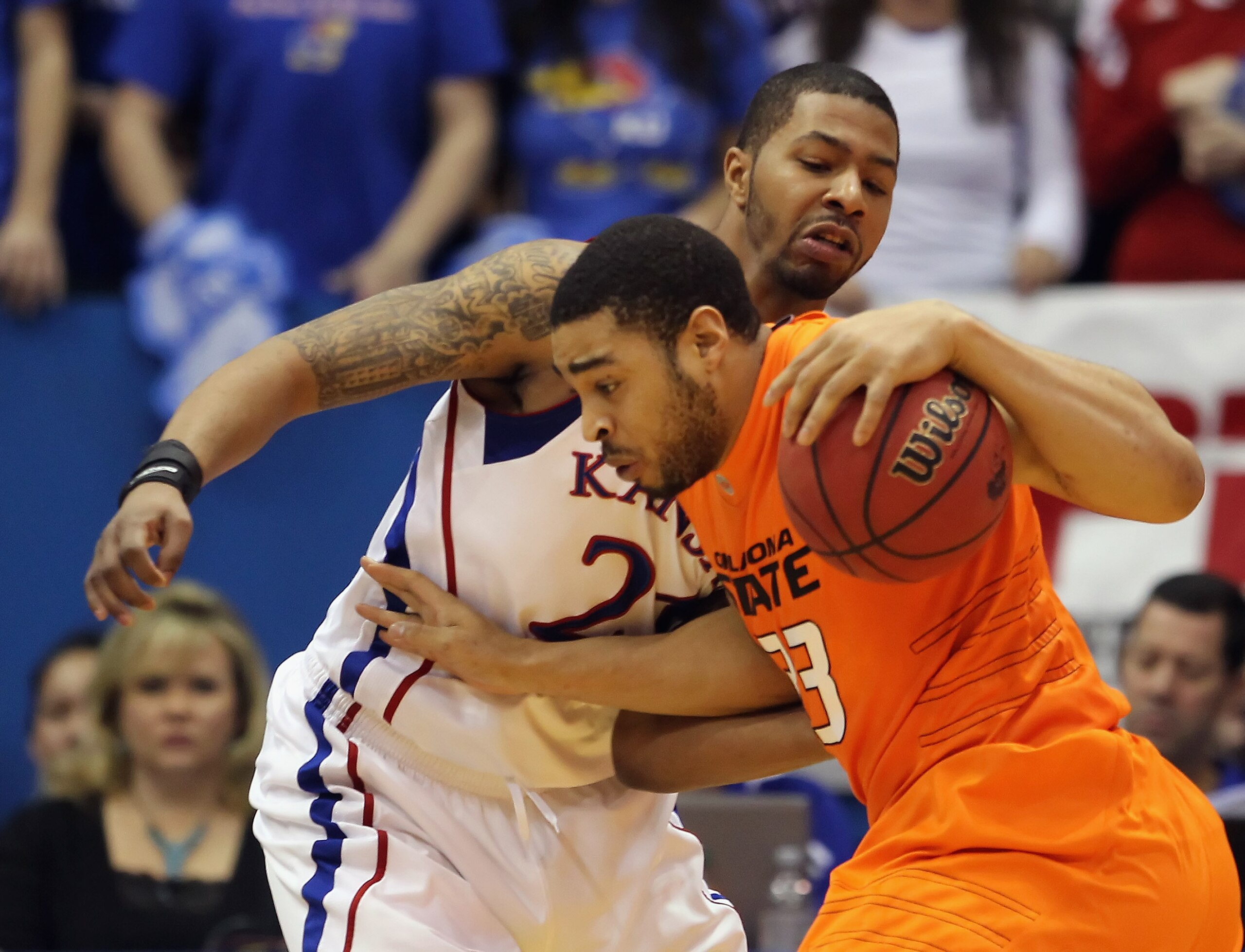 LAWRENCE, KS - FEBRUARY 21:  Marshall Moses #33 of the Oklahoma State Cowboys drives as Markieff Morris #21 of the Kansas Jayhawks defends during the game on February 21, 2011 at Allen Fieldhouse in Lawrence, Kansas.  (Photo by Jamie Squire/Getty Images)
