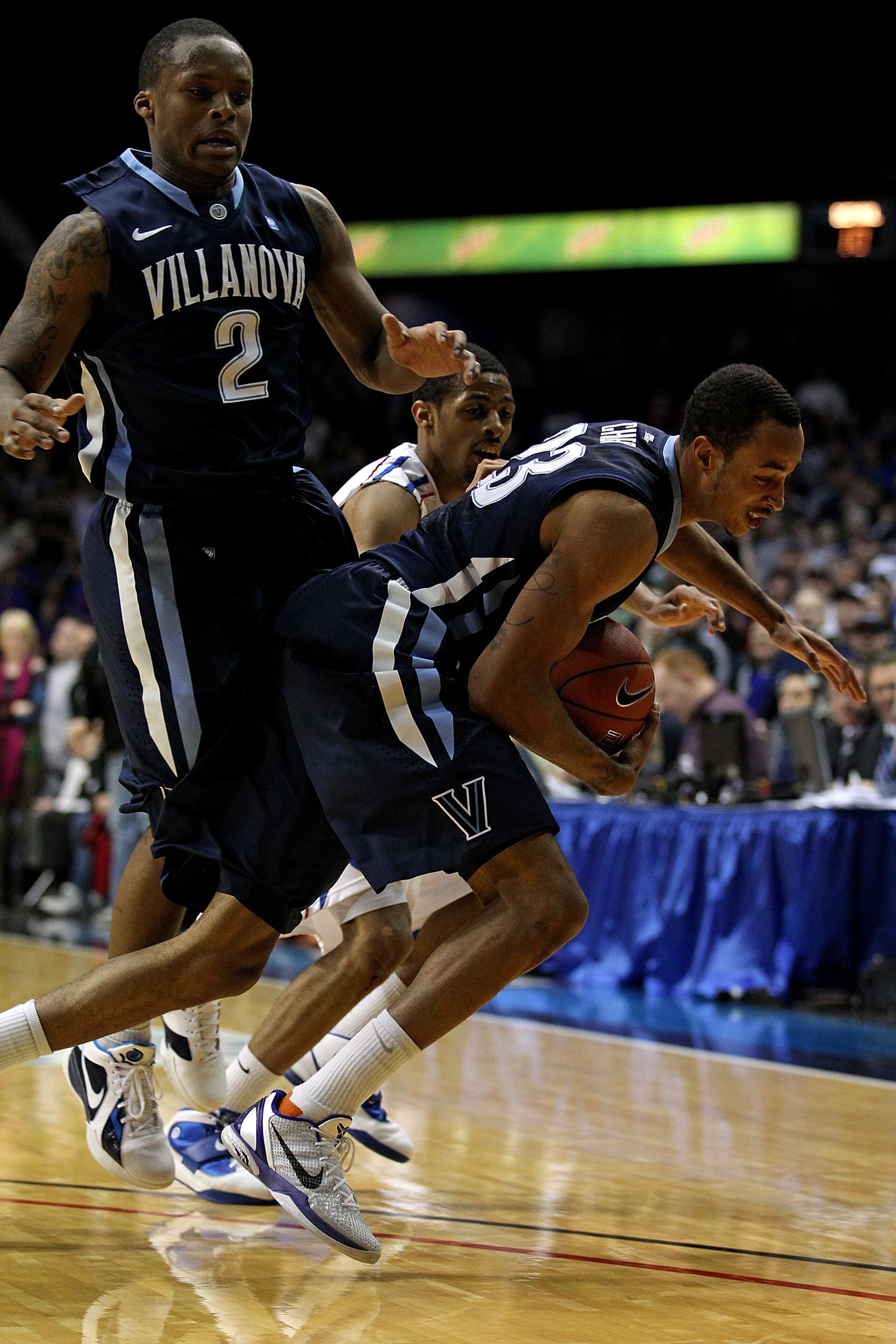 ROSEMONT, IL - FEBRUARY 19: Dominic Cheek #23 of the Villanova Wildcats controls the ball in front of teammate Maalik Wayns #2 and Jeremiah Kelly #11 of the DePaul Blue Demons at the Allstate Arena on February 19, 2011 in Rosemont, Illinois. Villanova def