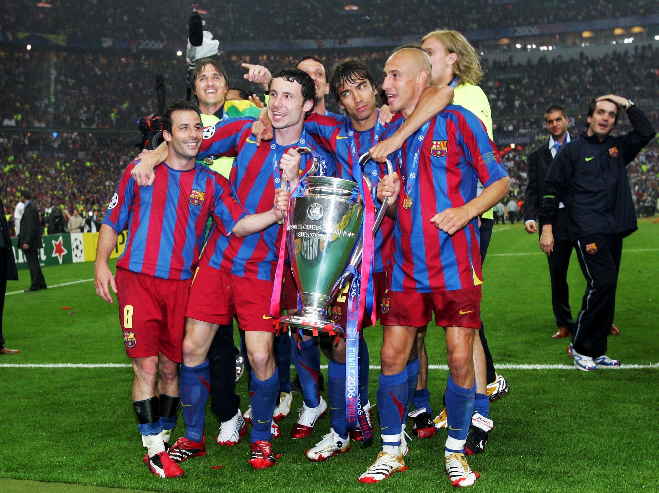 PARIS - MAY 17:  (L-R) Ludovic Giuly, Mark Van Bommel, Giovanni Van Bronckhorst and Henrik Larsson of Barcelona celebrate with the trophy after their team wins the UEFA Champions League Final between Arsenal and Barcelona at the Stade de France on May 17,