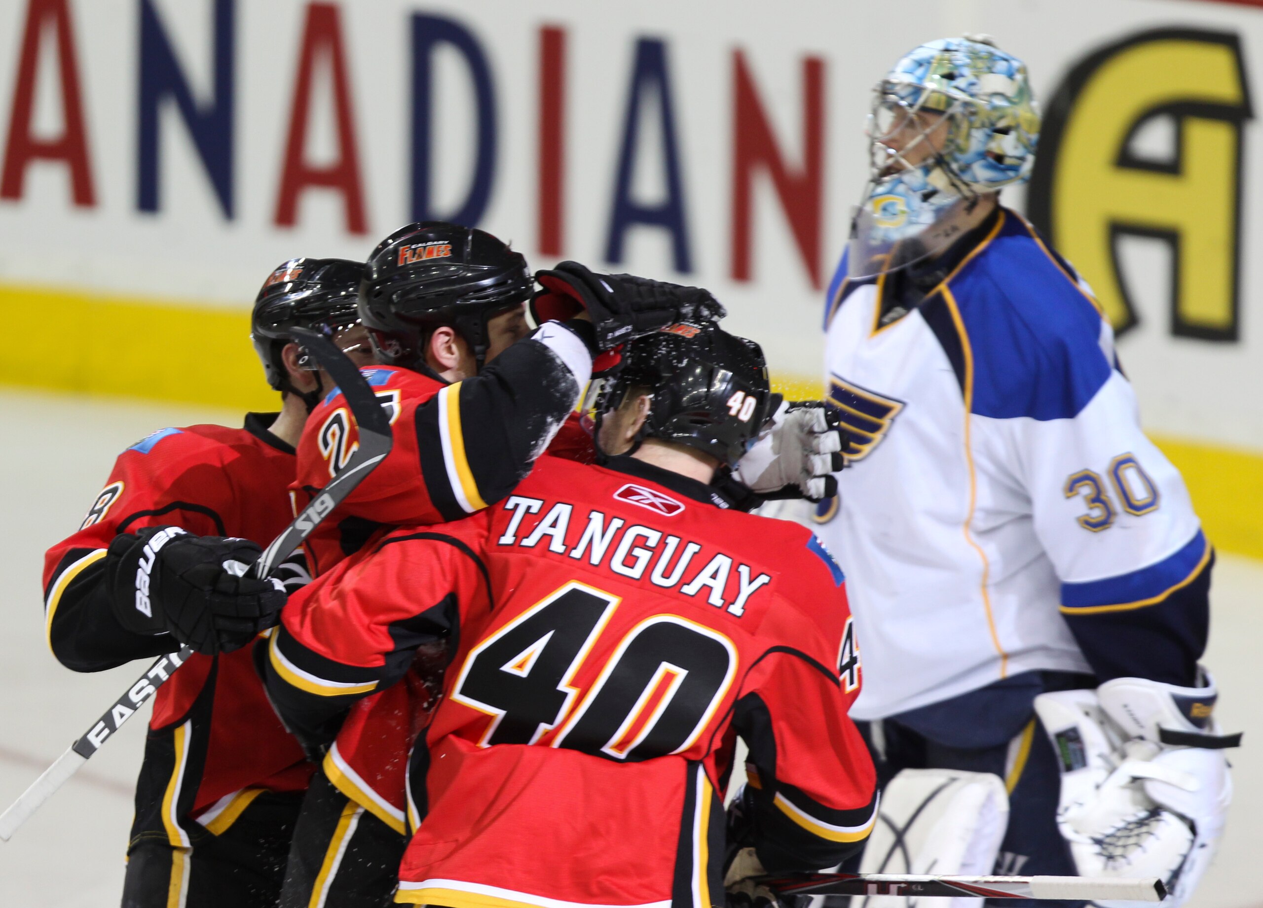 CALGARY, AB - FEBRUARY 27: David Moss #25 of the Calgary Flames celebrates his goal with teammate Alex Tanguay #40 in front of goaltender Ben Bishop #30 of the St. Louis Blues in the third period of NHL action on February 27, 2011 at the Scotiabank Saddle CALGARY, AB - FEBRUARY 27: David Moss #25 of the Calgary Flames celebrates his goal with teammate Alex Tanguay #40 in front of goaltender Ben Bishop #30 of the St. Louis Blues in the third period of NHL action on February 27, 2011 at the Scotiabank Saddle