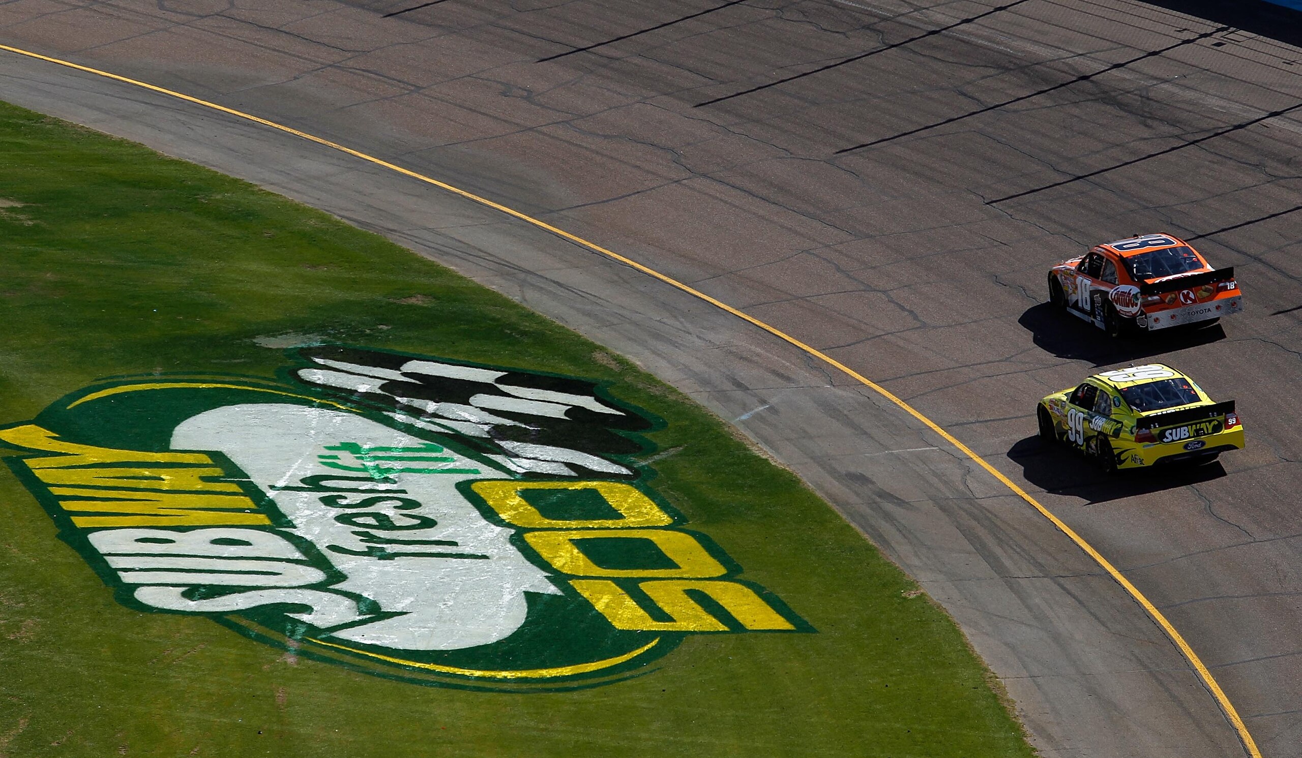 AVONDALE, AZ - FEBRUARY 27:  Kyle Busch, driver of the #18 Combos Toyota, leads Carl Edwards, driver of the #99 Subway Ford, during the NASCAR Sprint Cup Series Subway Fresh Fit 500 at Phoenix International Raceway on February 27, 2011 in Avondale, Arizon