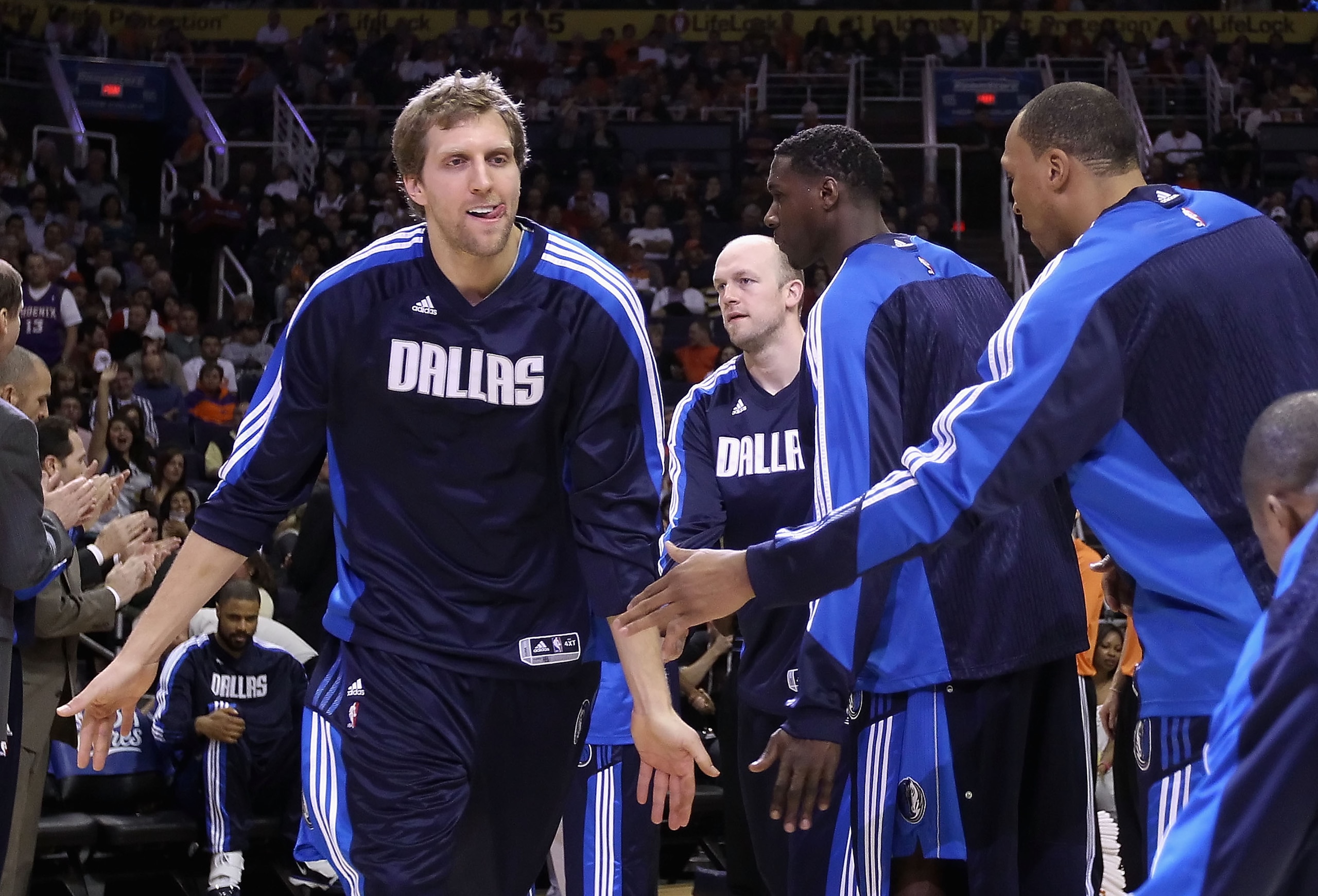 PHOENIX, AZ - FEBRUARY 17: Dirk Nowitzki #41 of the Dallas Mavericks high fives teammates during introductions to the NBA game against the Phoenix Suns at US Airways Center on February 17, 2011 in Phoenix, Arizona. NOTE TO USER: User expressly acknowled PHOENIX, AZ - FEBRUARY 17: Dirk Nowitzki #41 of the Dallas Mavericks high fives teammates during introductions to the NBA game against the Phoenix Suns at US Airways Center on February 17, 2011 in Phoenix, Arizona. NOTE TO USER: User expressly acknowled