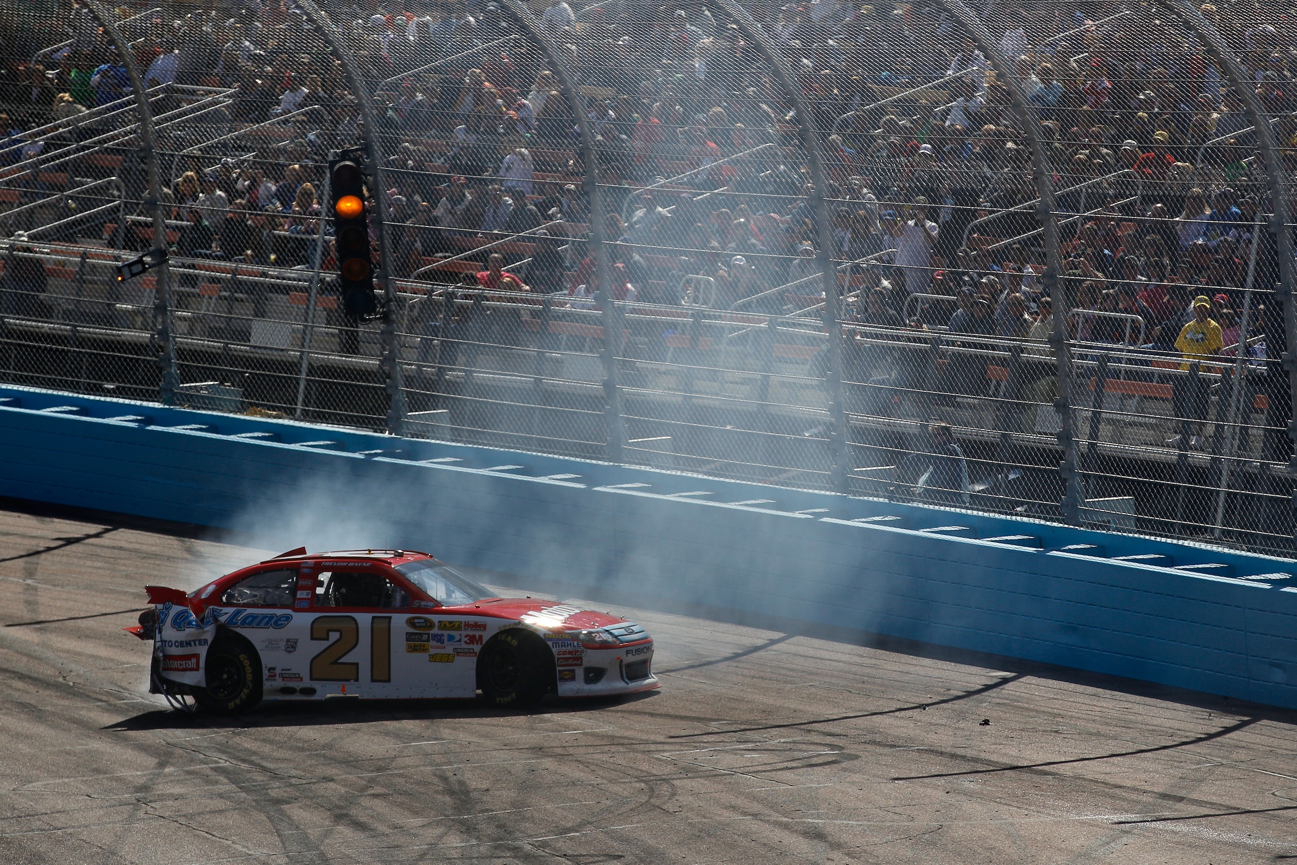 AVONDALE, AZ - FEBRUARY 27:  Trevor Bayne, driver of the #21 Motorcraft/Quick Lane Ford, loses control of his car during the NASCAR Sprint Cup Series Subway Fresh Fit 500 at Phoenix International Raceway on February 27, 2011 in Avondale, Arizona.  (Photo