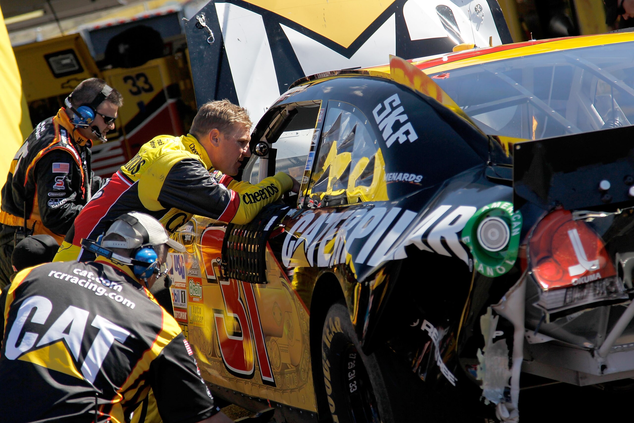AVONDALE, AZ - FEBRUARY 27:  Clint Bowyer, driver of the #33 Cheerios Chevrolet, talks to Jeff Burton, driver of the #31 Caterpilliar Chevrolet, in the garage after both were involved in a crash during the NASCAR Sprint Cup Series Subway Fresh Fit 500 at