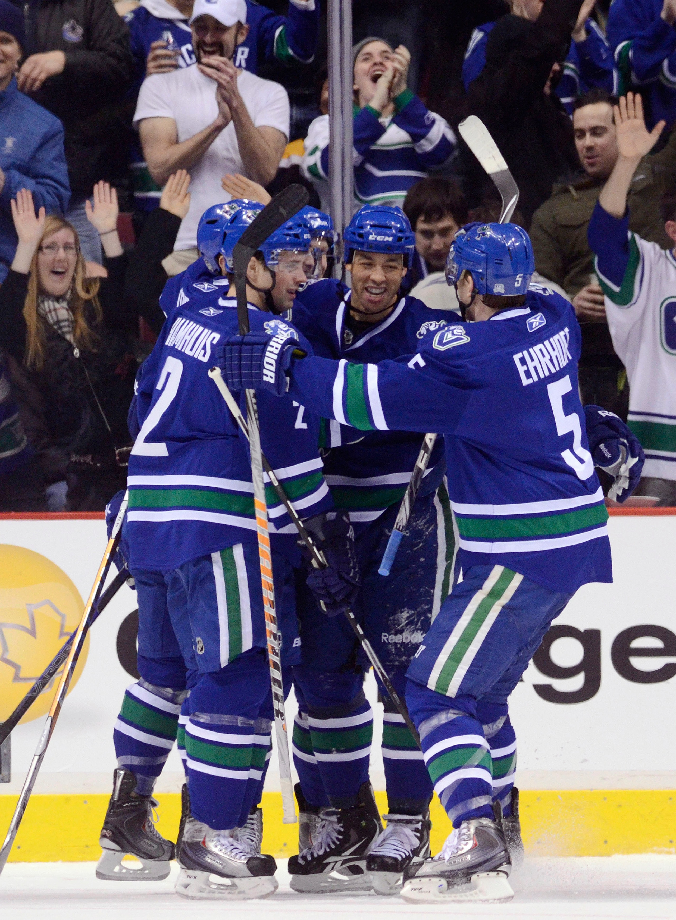 VANCOUVER, CANADA - FEBRUARY 26: Manny Malhotra #27 of the Vancouver Canucks is congratulated by Dan Hamhuis #2 and Christian Ehrhoff #5 after scoring against the Boston Bruins during the first period in NHL action on February 26, 2011 at Rogers Arena in VANCOUVER, CANADA - FEBRUARY 26: Manny Malhotra #27 of the Vancouver Canucks is congratulated by Dan Hamhuis #2 and Christian Ehrhoff #5 after scoring against the Boston Bruins during the first period in NHL action on February 26, 2011 at Rogers Arena in