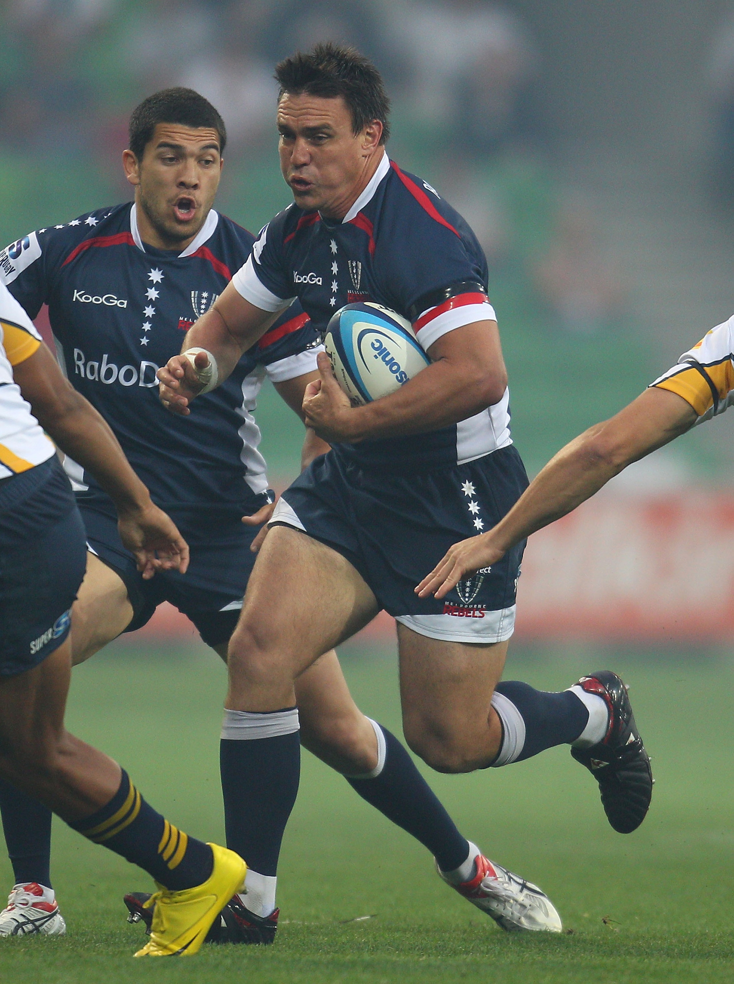MELBOURNE, AUSTRALIA - FEBRUARY 25:  Nic Henderson of the Rebels is tackled during the round two Super Rugby match between the Melbourne Rebels and the Brumbies at AAMI Park on February 25, 2011 in Melbourne, Australia.  (Photo by Scott Barbour/Getty Imag