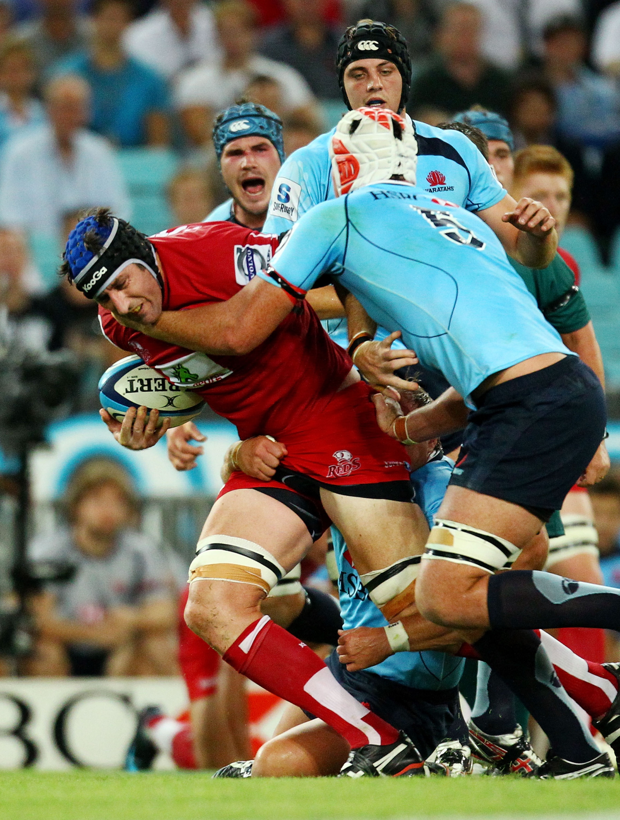 SYDNEY, AUSTRALIA - FEBRUARY 26: Van Humphries of the Reds is tackled during the round two Super Rugby match between the Waratahs and the Reds at ANZ Stadium on February 26, 2011 in Sydney, Australia.  (Photo by Mark Nolan/Getty Images)