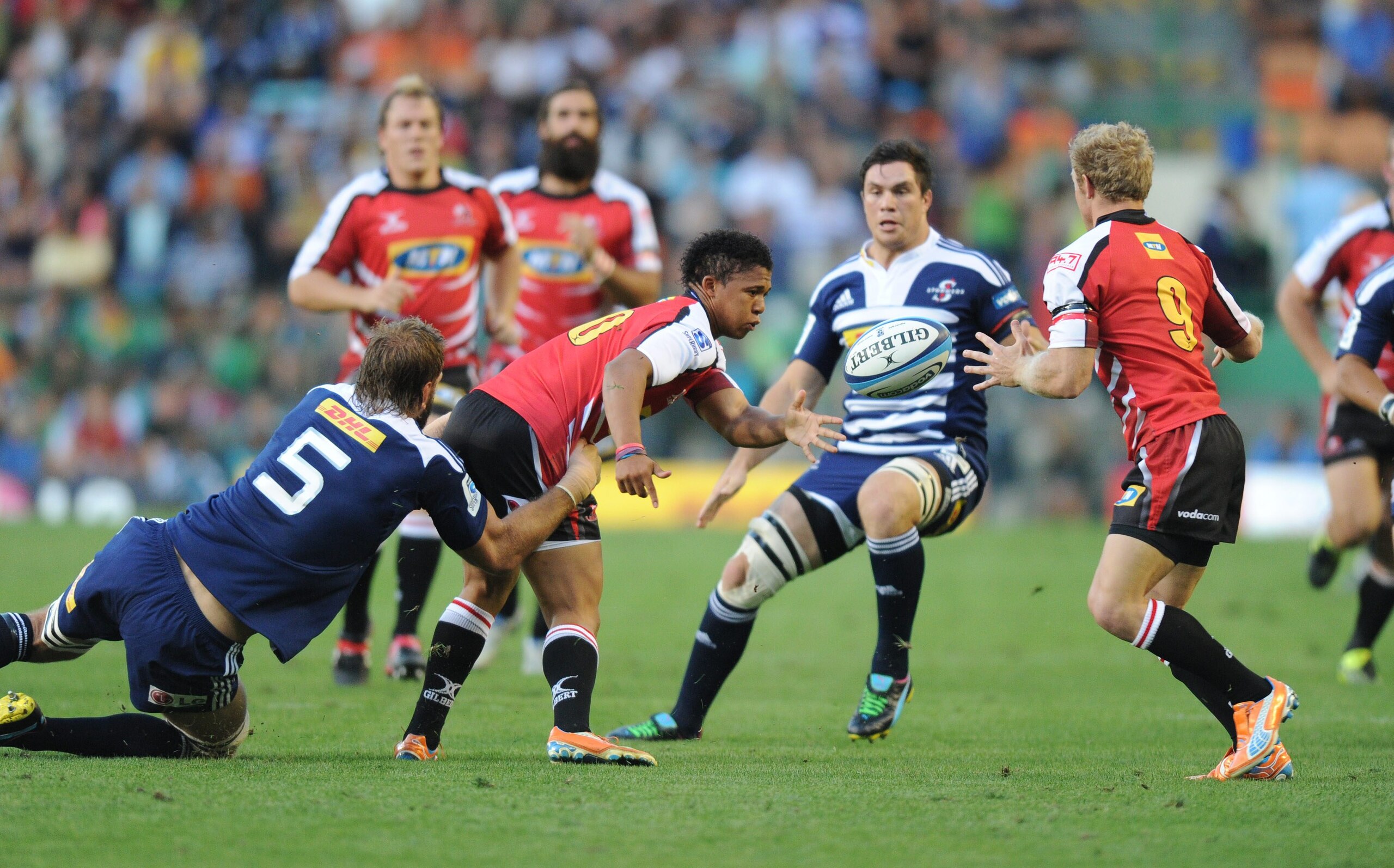 CAPE TOWN, SOUTH AFRICA - FEBRUARY 26:  Elton Jantjies of the Lions offloads to Jano Vermark of the Lions during the Super Rugby match between DHL Stormers and Lions at DHL Newlands Stadium on February 26, 2011 in Cape Town, South Africa. (Photo by Peter