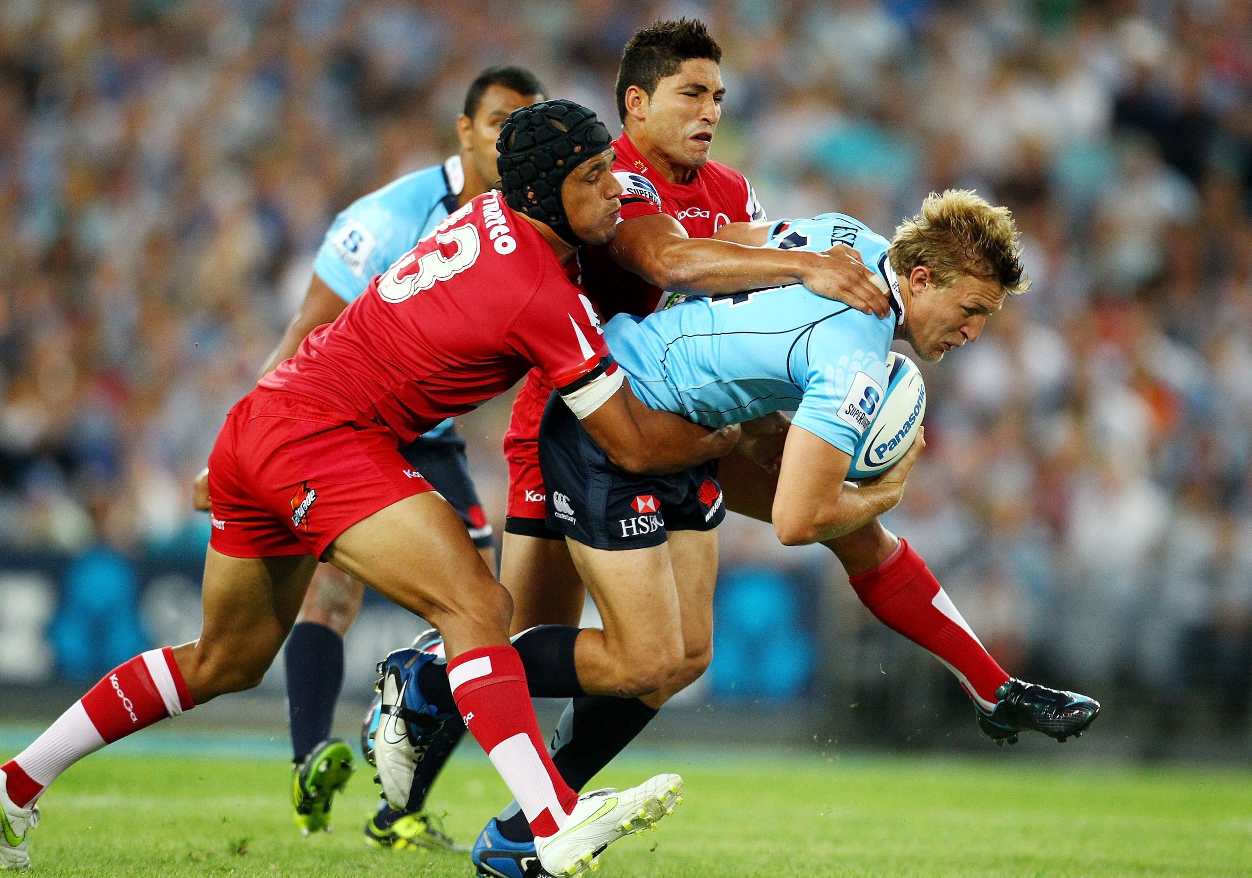 SYDNEY, AUSTRALIA - FEBRUARY 26:  Lachie Turner of the Waratahs is tackled  during the round two Super Rugby match between the Waratahs and the Reds at ANZ Stadium on February 26, 2011 in Sydney, Australia.  (Photo by Mark Nolan/Getty Images)