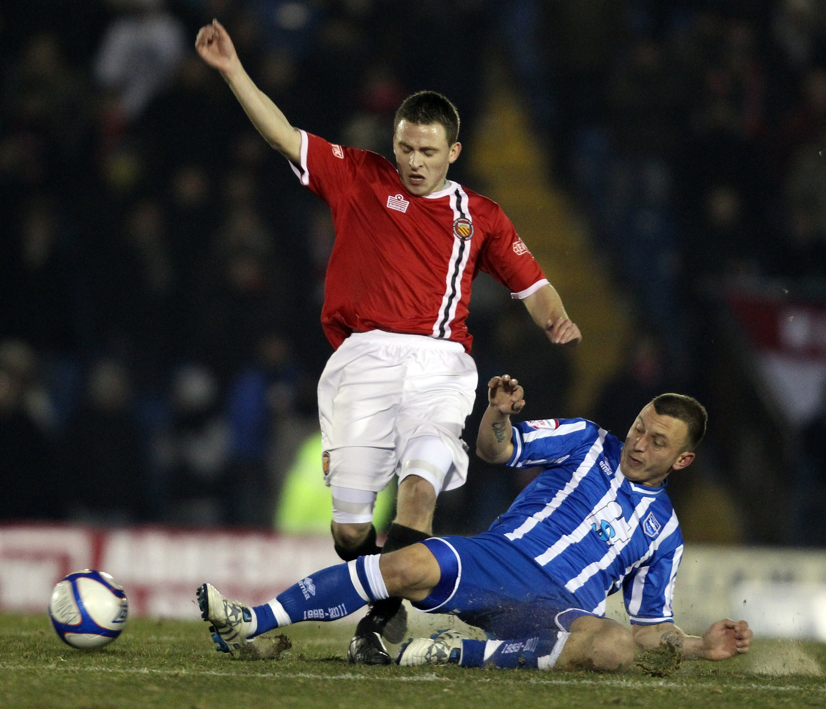 BURY, ENGLAND - DECEMBER 08:  Matthew Wolfenden of FC United is challenged by Gary Hart of Brighton  during the FA Cup sponsored by E.ON 2nd Round Replay between FC United of Manchester and Brighton & Hove Albion at Gigg Lane on December 8, 2010 in Bury,