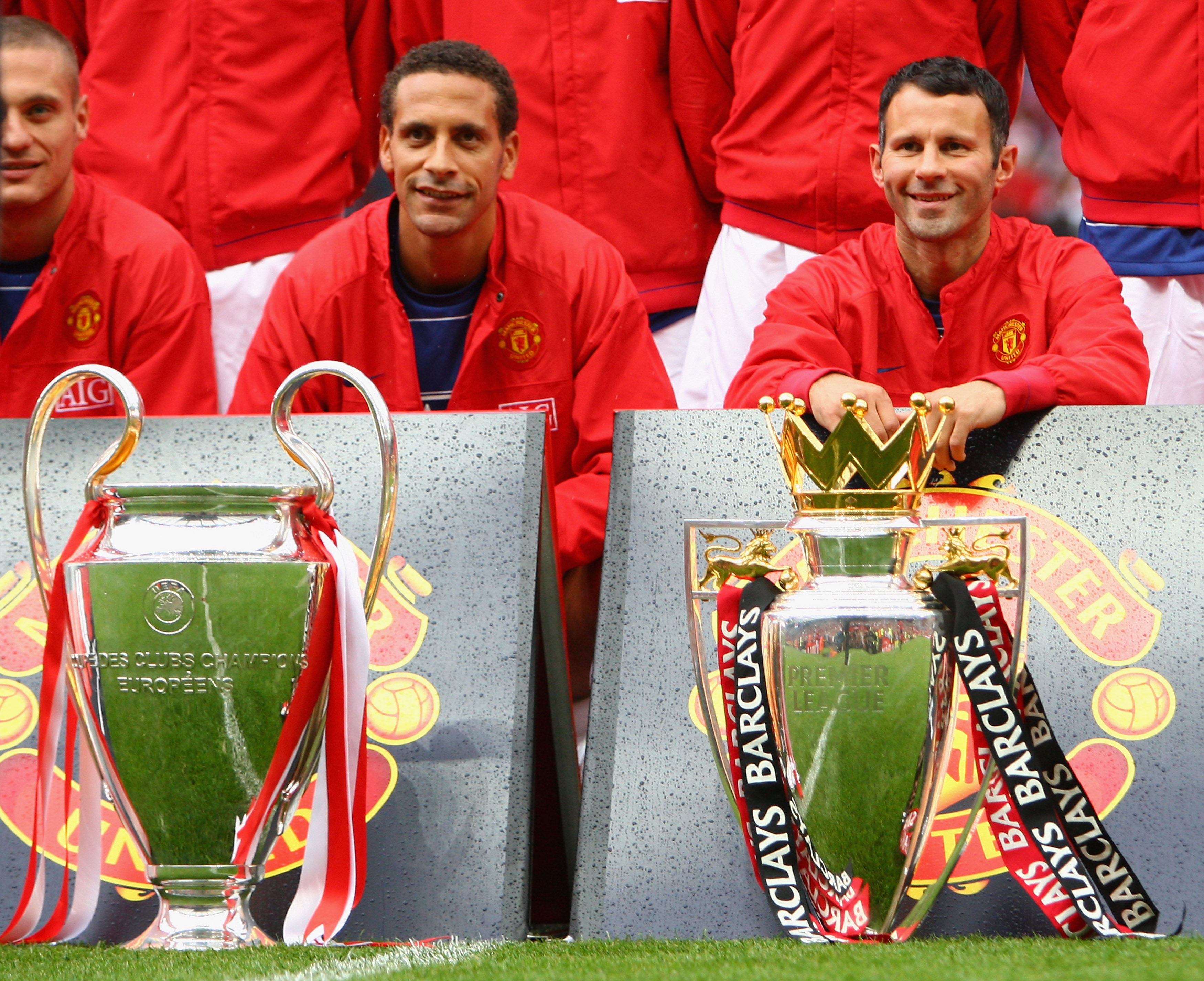 MANCHESTER, UNITED KINGDOM - AUGUST 06:  Rio Ferdinand of Manchester United and team mate Ryan Giggs (R) pose with the Premier League and Champions League trophies prior to the Pre Season Friendly match between Manchester United and Juventus at Old Traffo