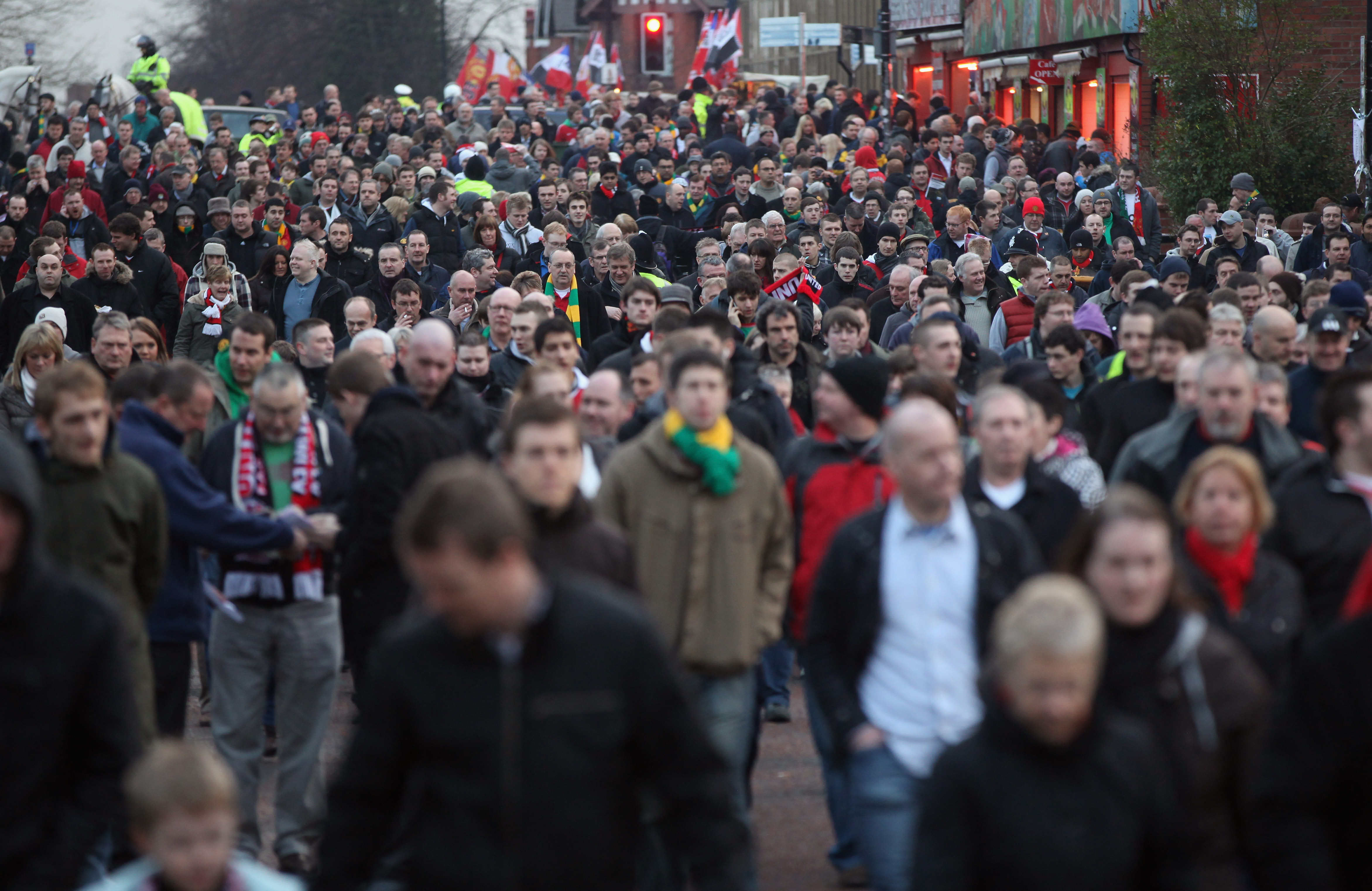 MANCHESTER, UNITED KINGDOM - FEBRUARY 19:  Fans of non league side Crawley Town and Manchester United mingle as they walk down Sir Matt Busby Way to Old Trafford for the FA Cup fifth round tie on February 19, 2011 in Manchester, England. The team from Wes