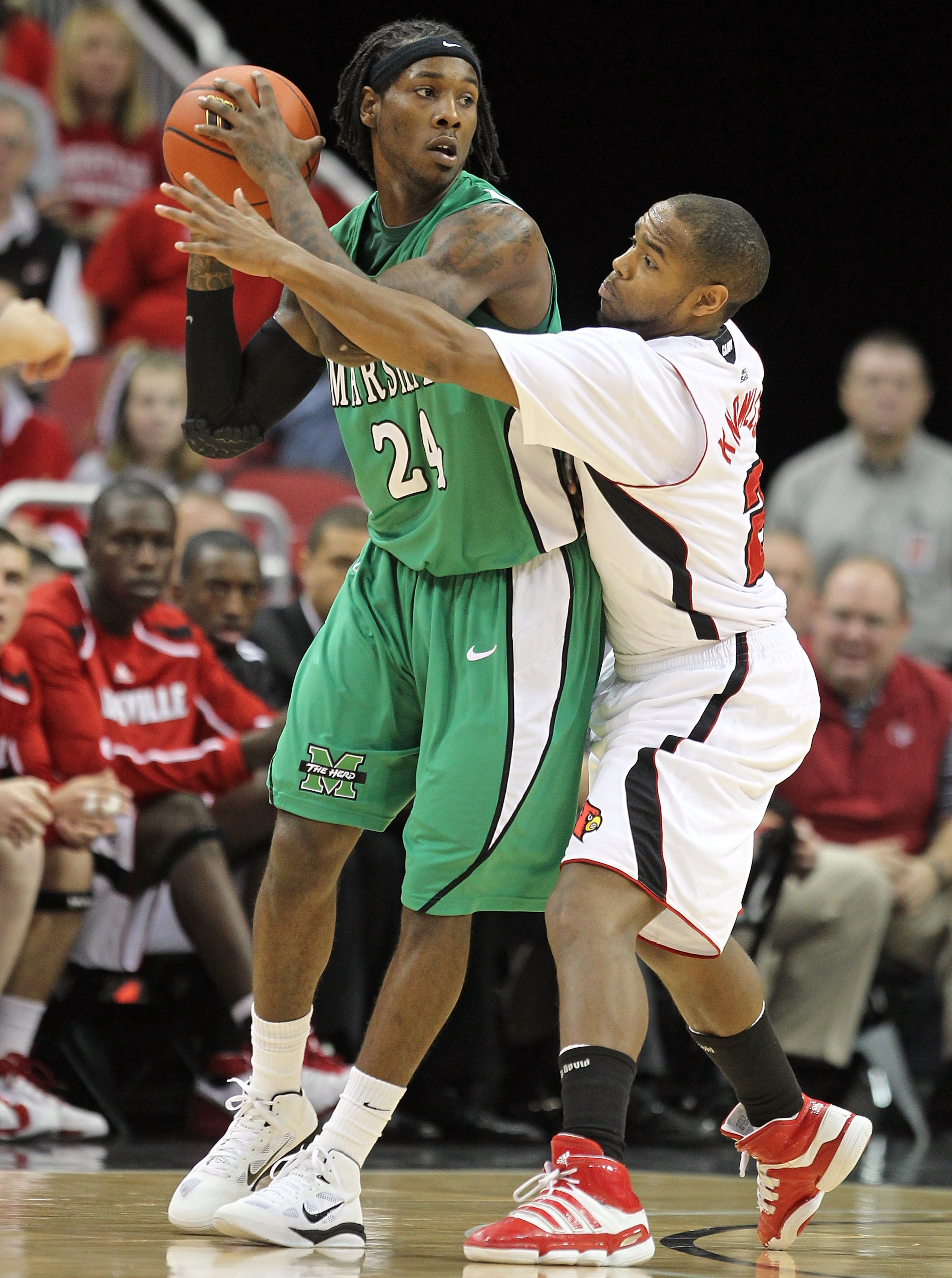 LOUISVILLE, KY - NOVEMBER 27: Preston Knowles #2 of the Louisville Cardinals defends DeAndre Kane #24 of the Marshall Thundering Herd during the game at the KFC Yum! Center on November 27, 2010 in Louisville, Kentucky.  Louisville won 80-66.  (Photo by An