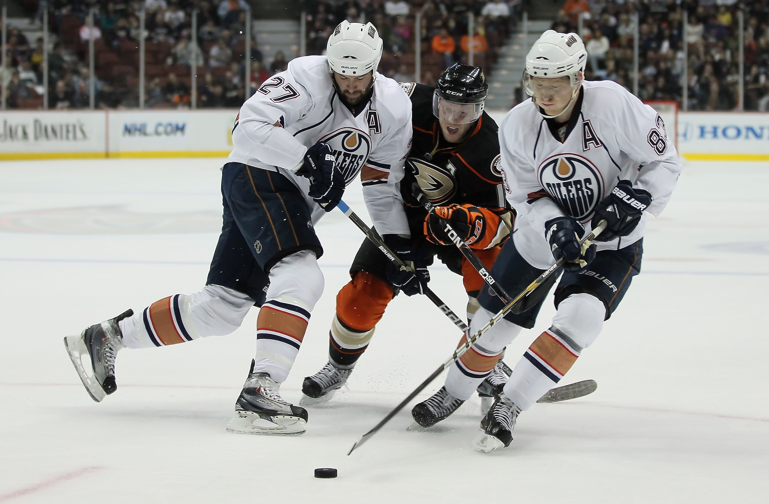 ANAHEIM, CA - JANUARY 16: (L-R) Dustin Penner #27 of the Edmonton Oilers defends against Saku Koivu #11 of the Anaheim Ducks as Ales Hemsky #83 of the Oilers controls the puck in the first period at the Honda Center on January 16, 2011 in Anaheim, Califo ANAHEIM, CA - JANUARY 16: (L-R) Dustin Penner #27 of the Edmonton Oilers defends against Saku Koivu #11 of the Anaheim Ducks as Ales Hemsky #83 of the Oilers controls the puck in the first period at the Honda Center on January 16, 2011 in Anaheim, Califo