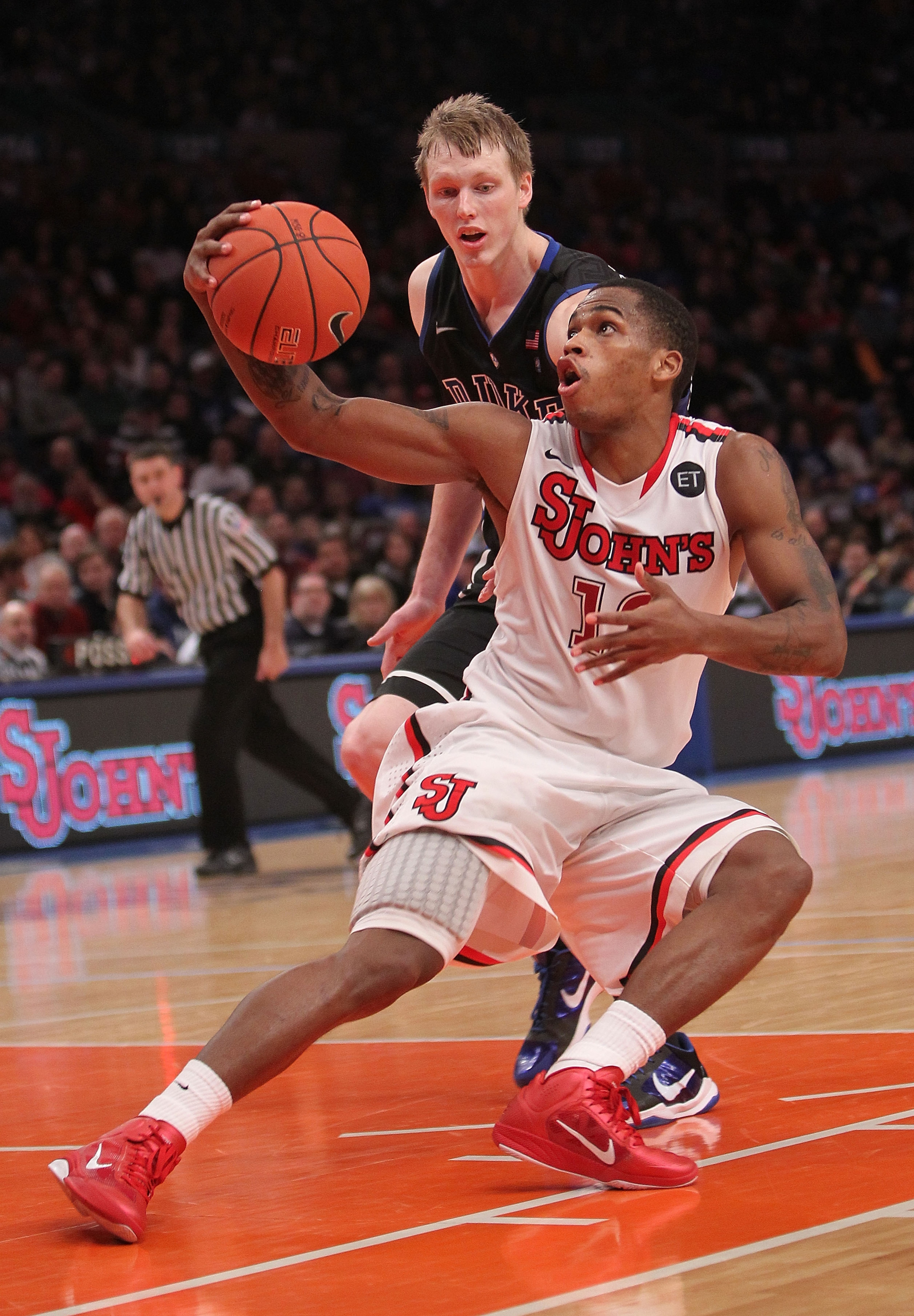 NEW YORK, NY - JANUARY 30: Dwight Hardy #12 of the St. John's Red Storm fakes in front of Kyle Singler #12 of the Duke Blue Devils  at Madison Square Garden on January 30, 2011 in New York City.  (Photo by Nick Laham/Getty Images)