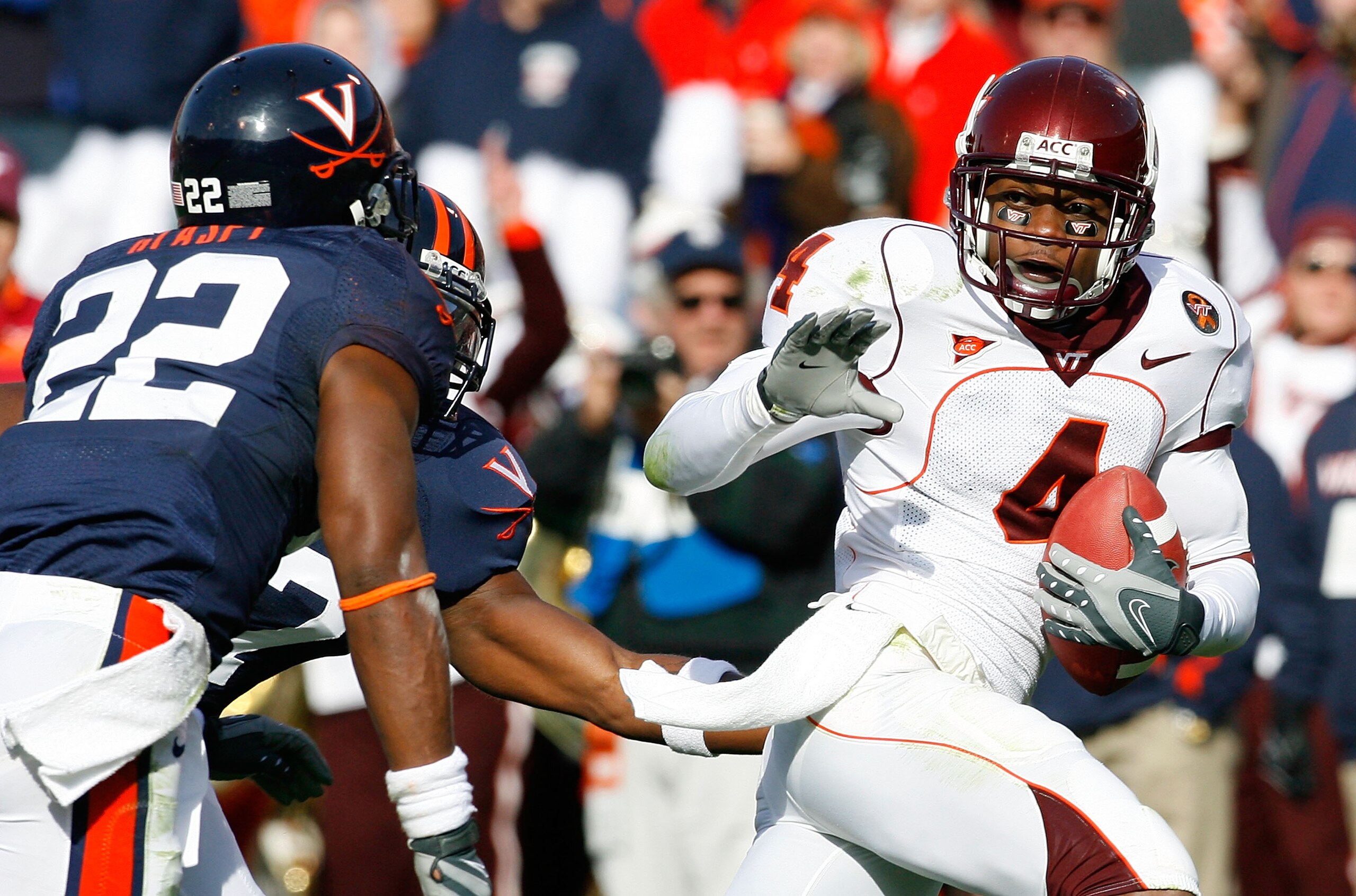 CHARLOTTESVILLE, VA - NOVEMBER 24:  Eddie Royal #4 of the Virginia Tech Hokies rushes in for a touchdown in front of defenders Byron Glaspy #22 and Jamaal Jackson #27 of the Virginia Cavaliers during the first half at Scott Stadium on November 24, 2007 in