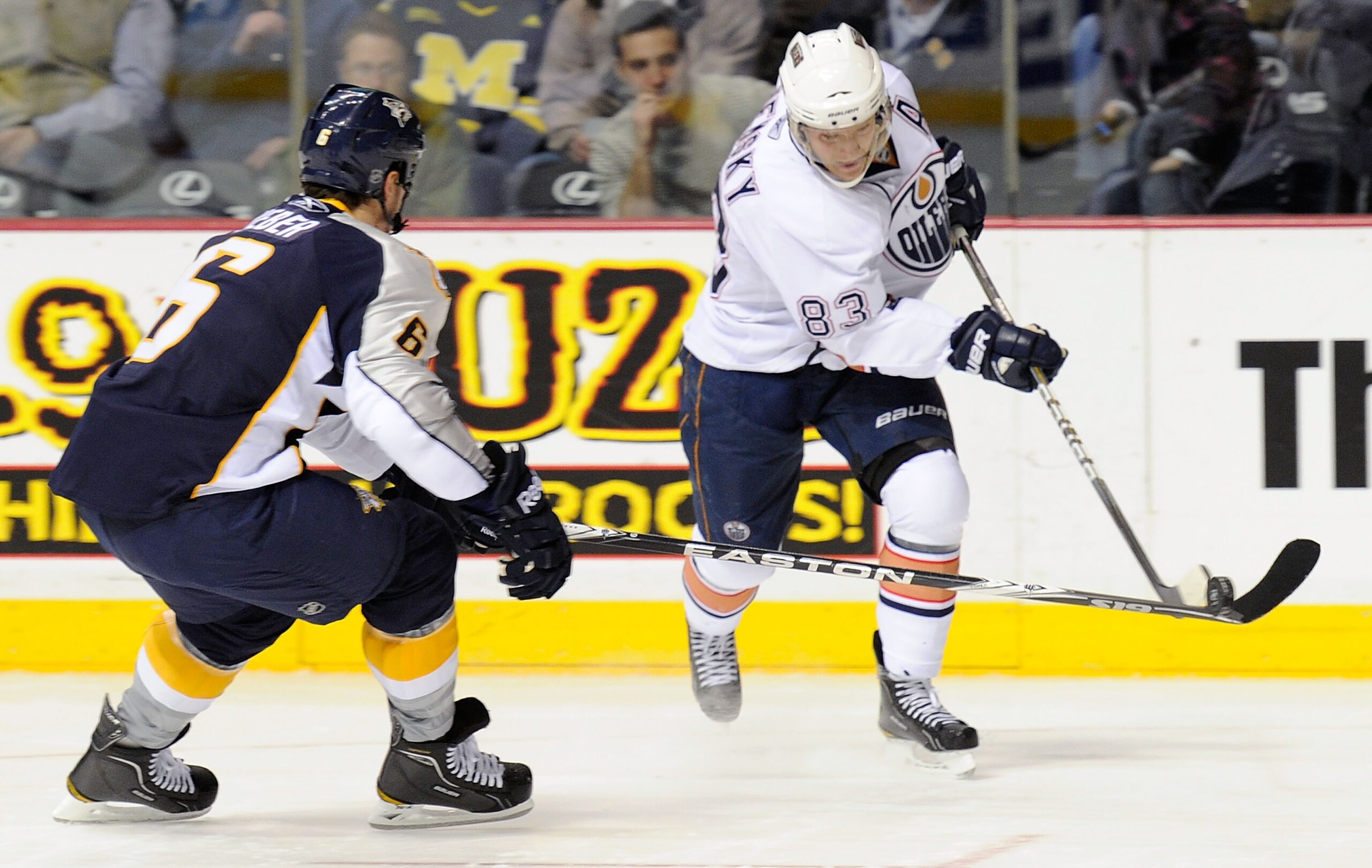 NASHVILLE, TN - FEBRUARY 07:   Alex Hemsky #83 of the Edmonton Oilers dumps the puck past Shea Weber #6 of the Nashville Predatorson February 7, 2011 at the Bridgestone Arena in Nashville, Tennessee.  (Photo by Frederick Breedon/Getty Images)