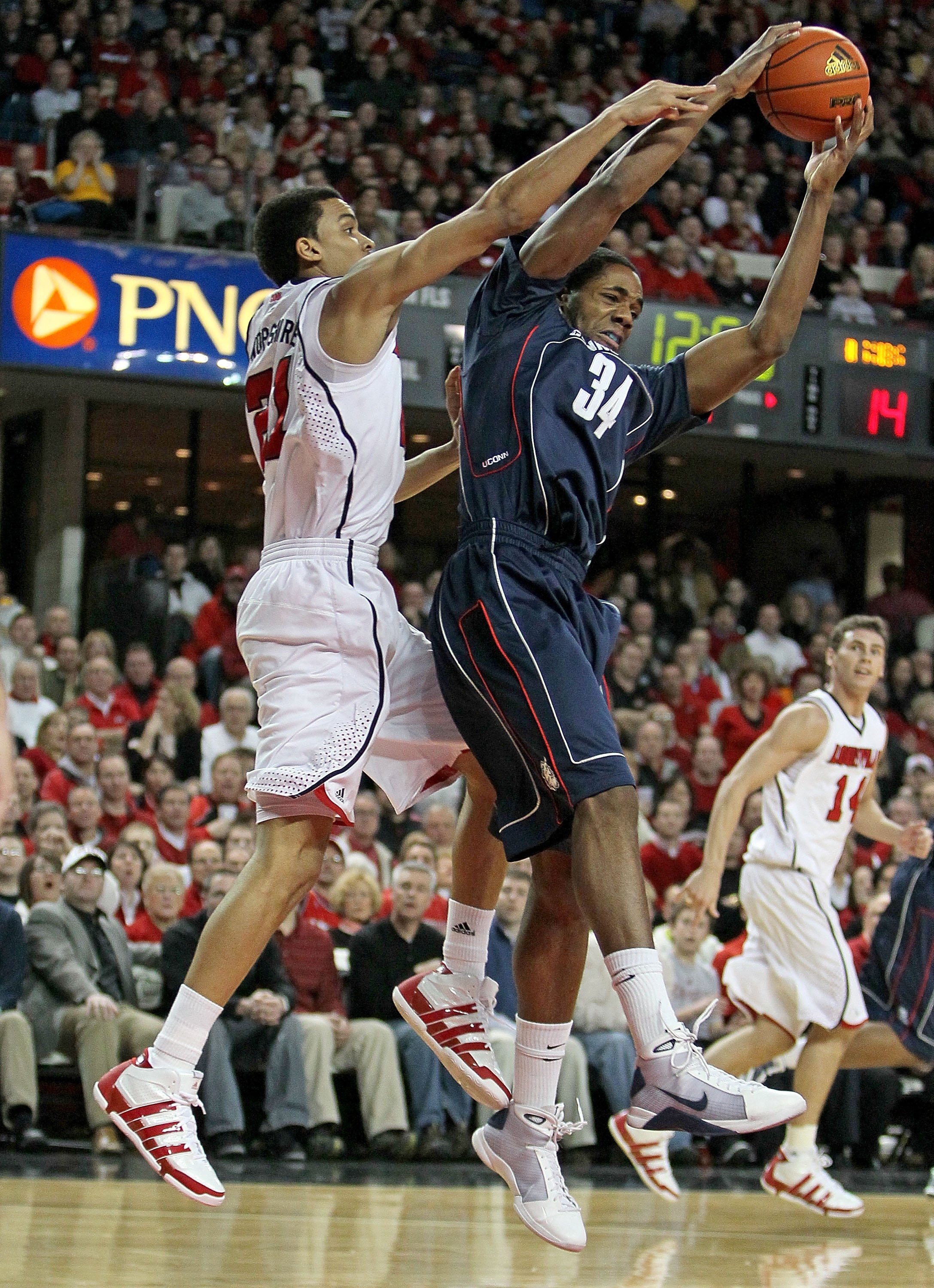 LOUISVILLE, KY - FEBRUARY 01:  Jared Swopshire #21 of the Louisville Cardinals defends Alex Oriakhi #34 of the Connecticut Huskies during the Big East Conference game on February 1, 2010 at Freedom Hall in Louisville, Kentucky.  Louisville won 82-69.  (Ph