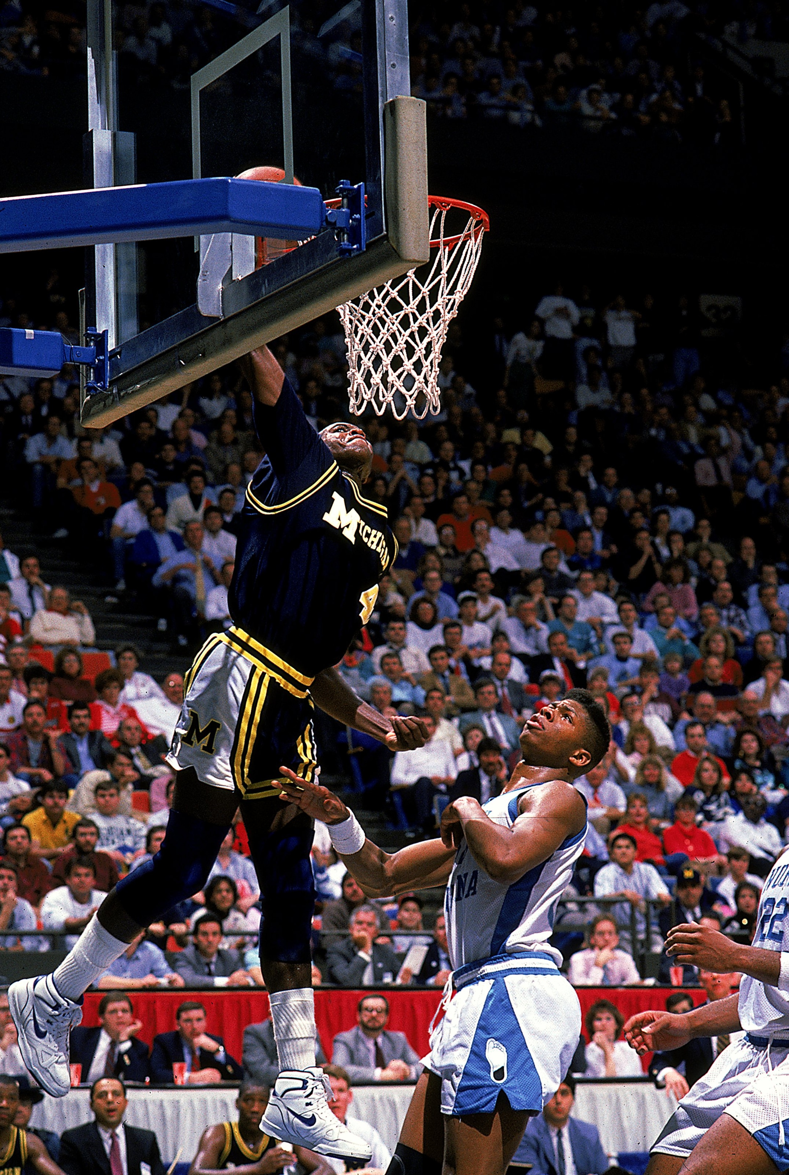 Glen Rice #4 of the University of Michigan Wolverines makes a slam dunk during the game against the North Carolina Tar Heels.