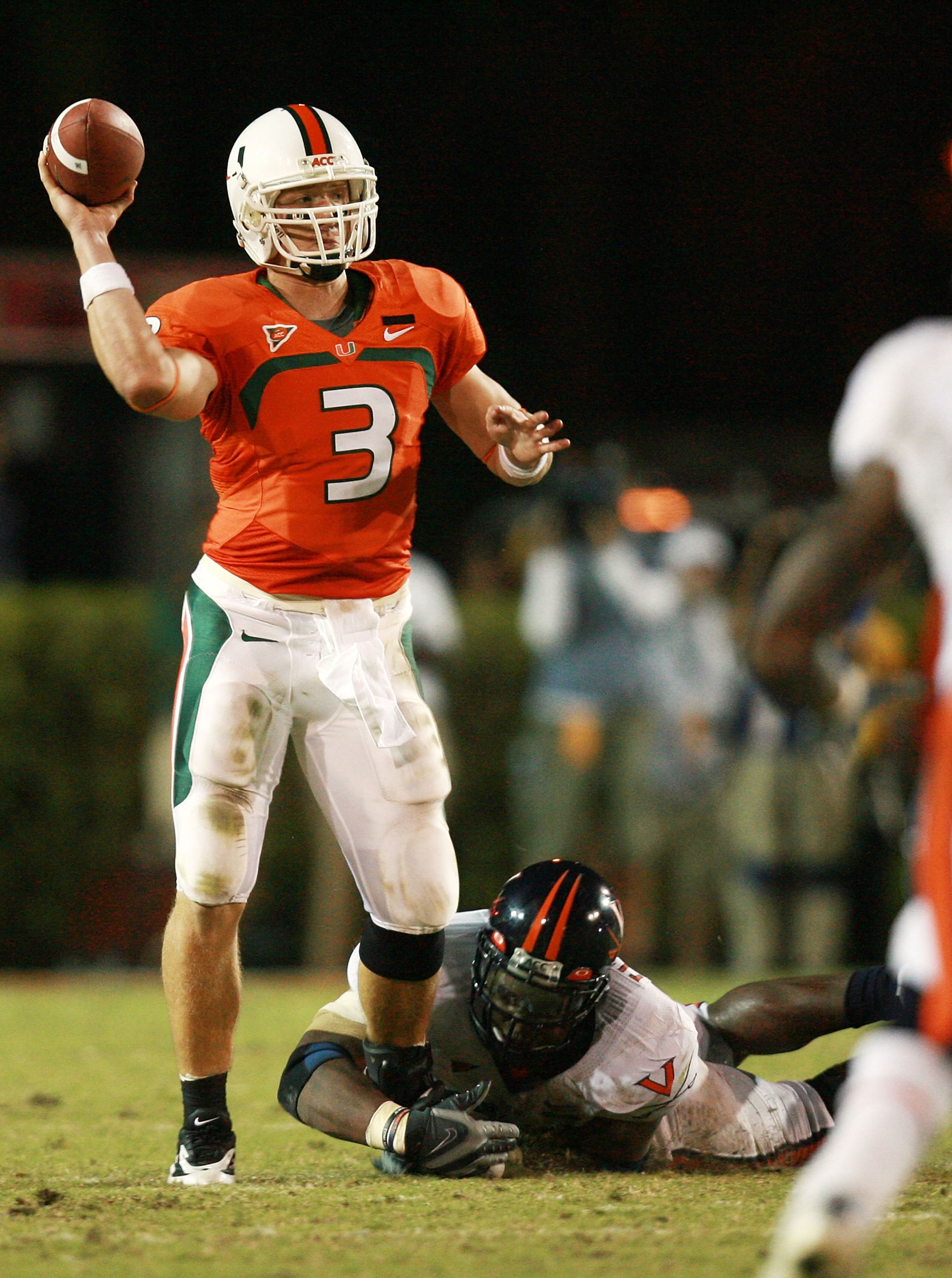 CORAL GABLES, FL - NOVEMBER 10:  Quarterback Kyle Wright #3 of the Miami Hurricanes gets the pass off despite the defensive pressure the Virginia Cavaliers at the Orange Bowl November 10, 2007 in Coral Gables, Florida.  (Photo by Doug Benc/Getty Images)