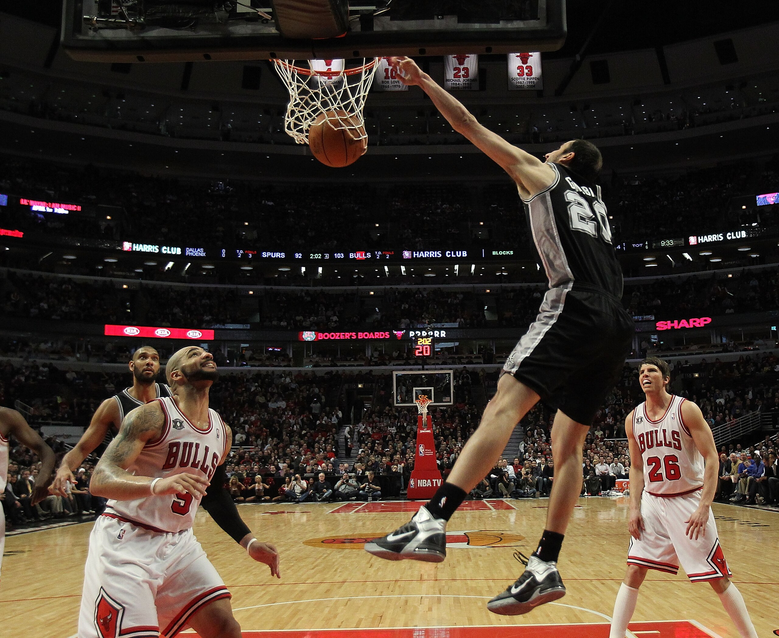 CHICAGO, IL - FEBRUARY 17: Manu Ginobili #20 of the San Antonio Spurs dunks the ball over Carlos Boozer #5 of the Chicago Bulls at the United Center on February 17, 2011 in Chicago, Illinois. The Bulls defeated the Spurs 109-99. NOTE TO USER: User express