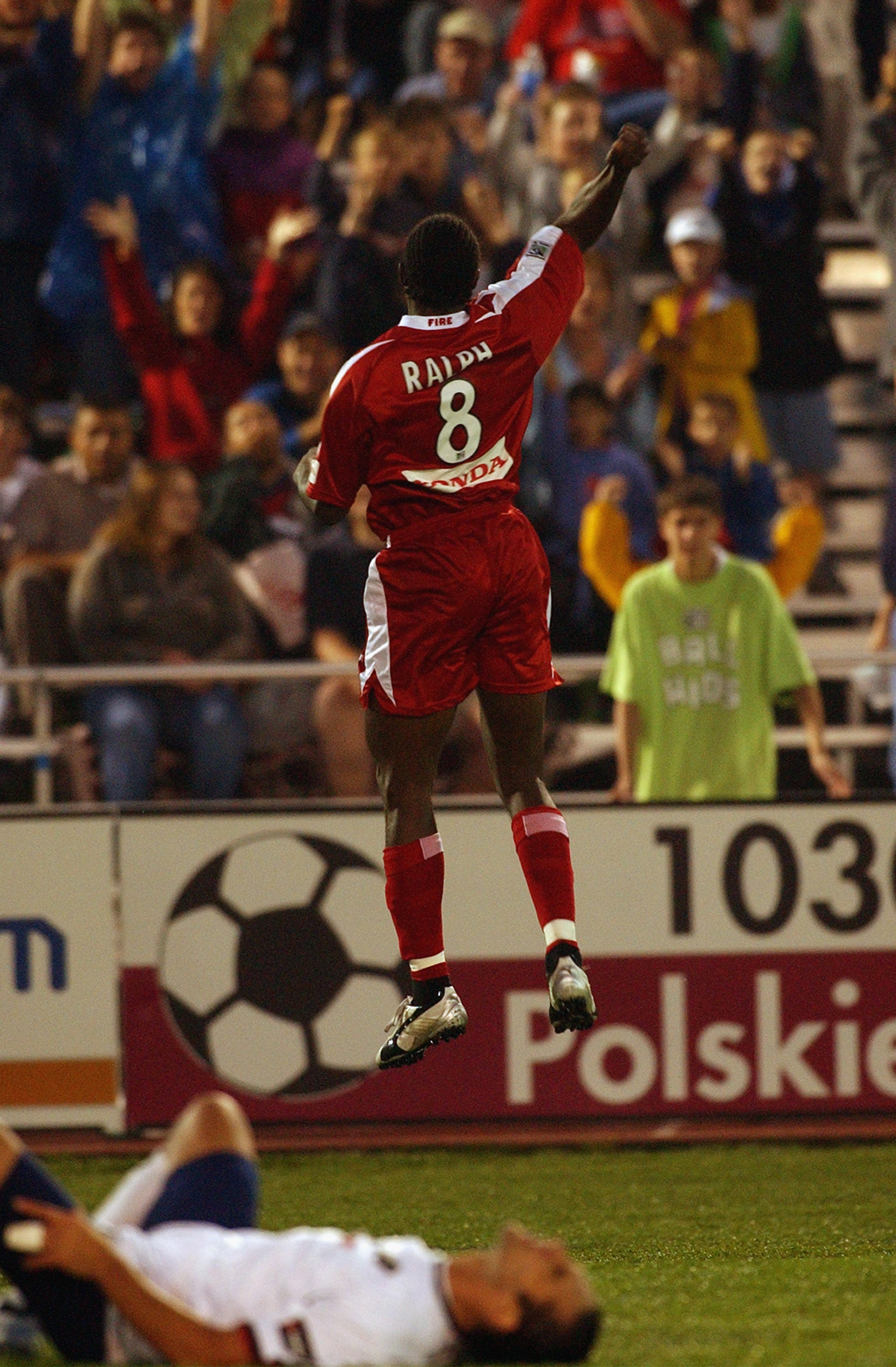 NAPERVILLE, IL - JUNE 18:  Damani Ralph #8 of the Chicago Fire celebrates during their MLS game on June 18, 2003 at Cardinal Stadium in Naperville, Illinois. The Fire defeated the Burn 4-1.  (Photo by Jonathan Daniel/Getty Images)