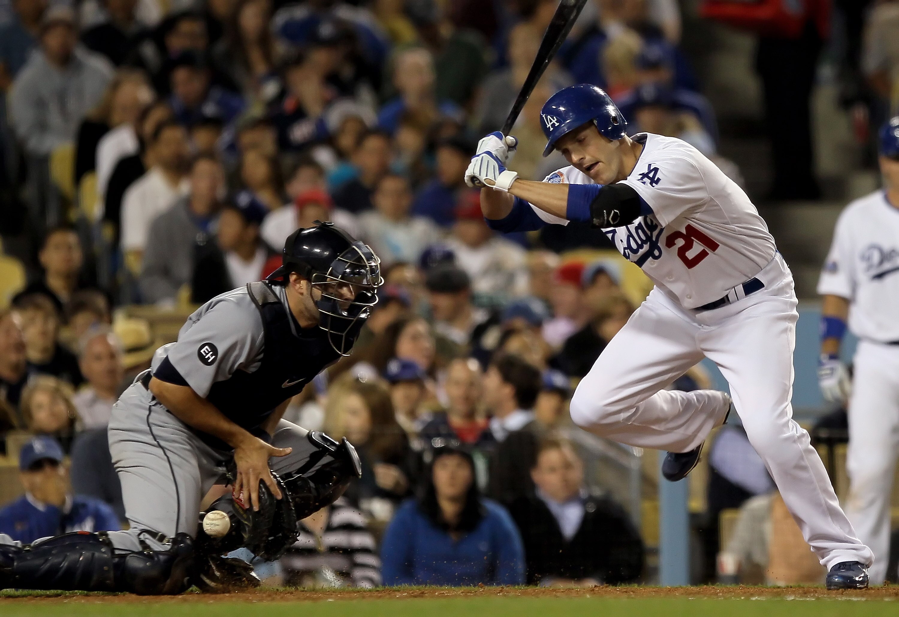 LOS ANGELES, CA - MAY 21:  Nick Green #21 of the Los Angeles Dodgers is hit in the foot by a pitch allowing a run to score as catcher Alex Avila #13 of the Detroit Tigers stops the ball in the fourth inning during the interleague game at Dodger Stadium on