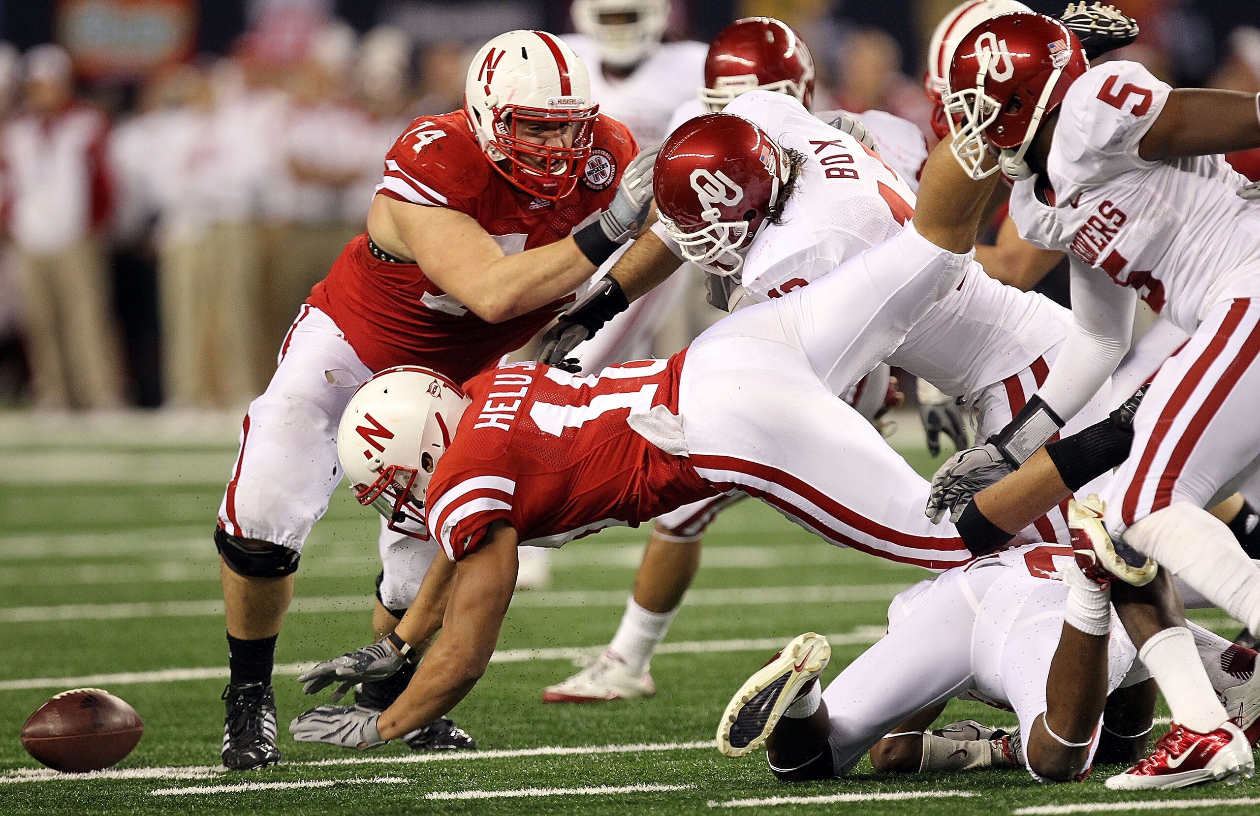 ARLINGTON, TX - DECEMBER 04:  Running back Roy Helu Jr. #10 of the Nebraska Cornhuskers fumbles the ball against the Oklahoma Sooners during the Big 12 Championship at Cowboys Stadium on December 4, 2010 in Arlington, Texas.  (Photo by Ronald Martinez/Get