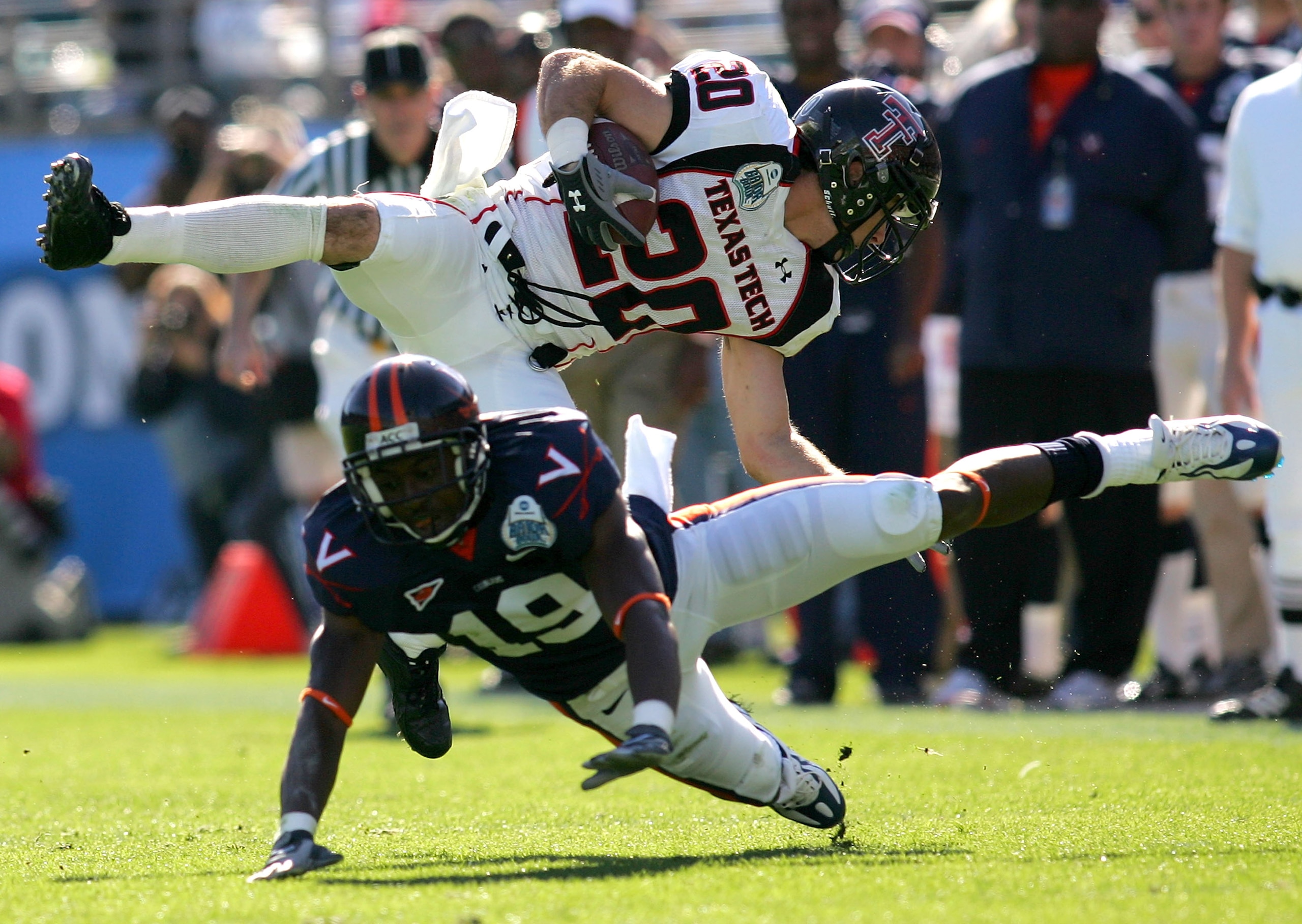JACKSONVILLE, FL - JANUARY 01: Danny Amendola #20 of the Texas Tech Red Raiders is tackled by Ras-I Dowling #19 of the Virginia Cavaliers during the Gator Bowl at Jacksonville Municipal Stadium on January 1, 2008 in Jacksonville, Florida. (Photo by Sam JACKSONVILLE, FL - JANUARY 01: Danny Amendola #20 of the Texas Tech Red Raiders is tackled by Ras-I Dowling #19 of the Virginia Cavaliers during the Gator Bowl at Jacksonville Municipal Stadium on January 1, 2008 in Jacksonville, Florida. (Photo by Sam