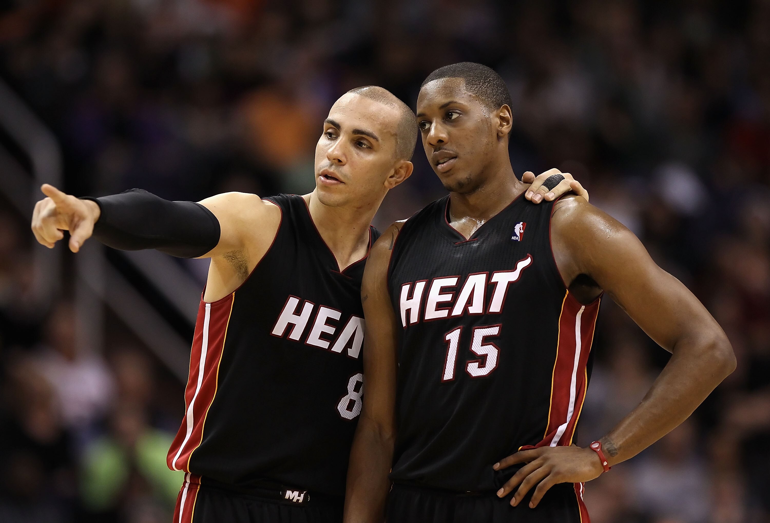 PHOENIX - DECEMBER 23:  Carlos Arroyo #8 and Mario Chalmers #15 of the Miami Heat talk during the NBA game against the Phoenix Suns at US Airways Center on December 23, 2010 in Phoenix, Arizona. The Heat defeated the Suns 95-83.  NOTE TO USER: User expres