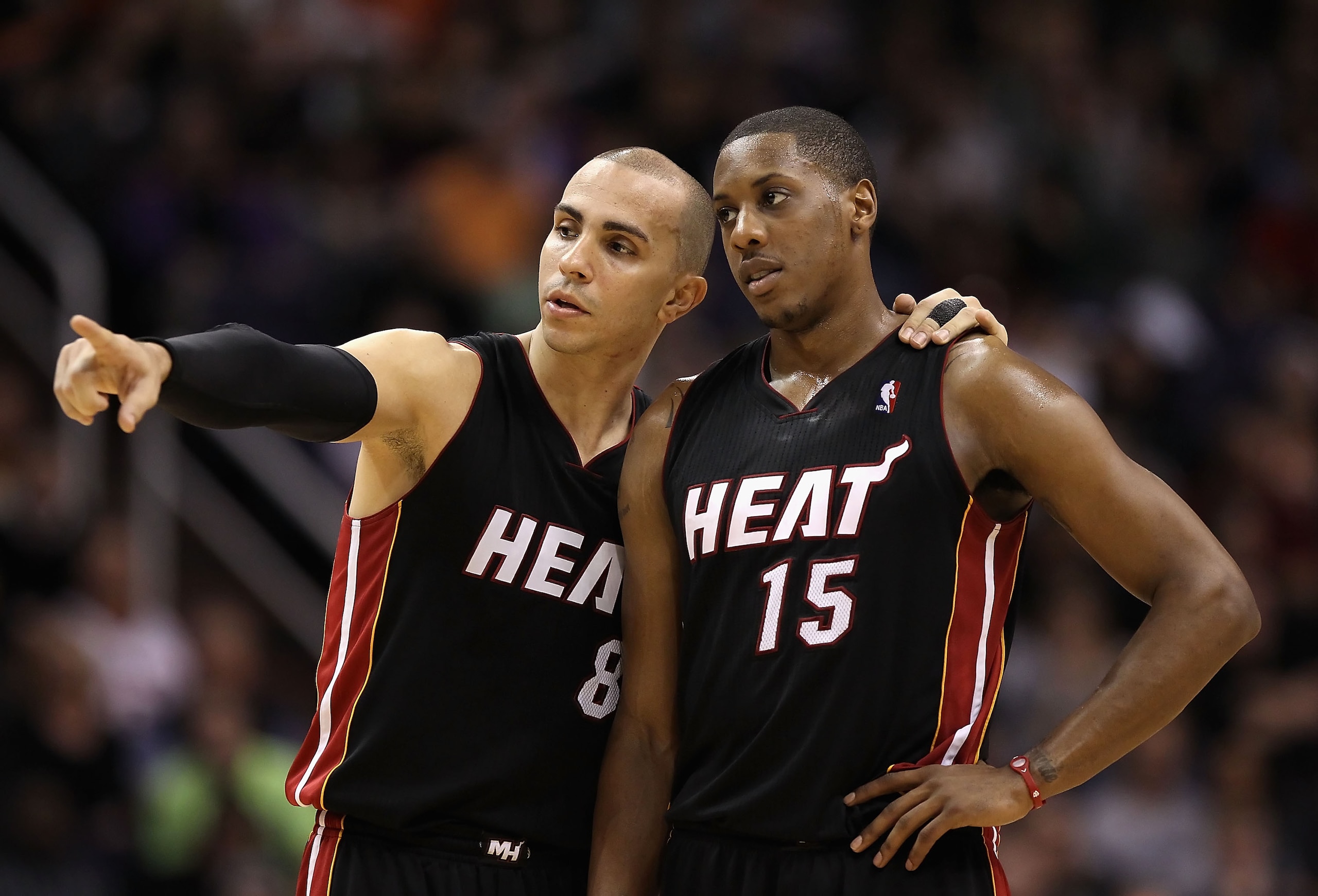 PHOENIX - DECEMBER 23: Carlos Arroyo #8 and Mario Chalmers #15 of the Miami Heat talk during the NBA game against the Phoenix Suns at US Airways Center on December 23, 2010 in Phoenix, Arizona. The Heat defeated the Suns 95-83. NOTE TO USER: User expres PHOENIX - DECEMBER 23: Carlos Arroyo #8 and Mario Chalmers #15 of the Miami Heat talk during the NBA game against the Phoenix Suns at US Airways Center on December 23, 2010 in Phoenix, Arizona. The Heat defeated the Suns 95-83. NOTE TO USER: User expres